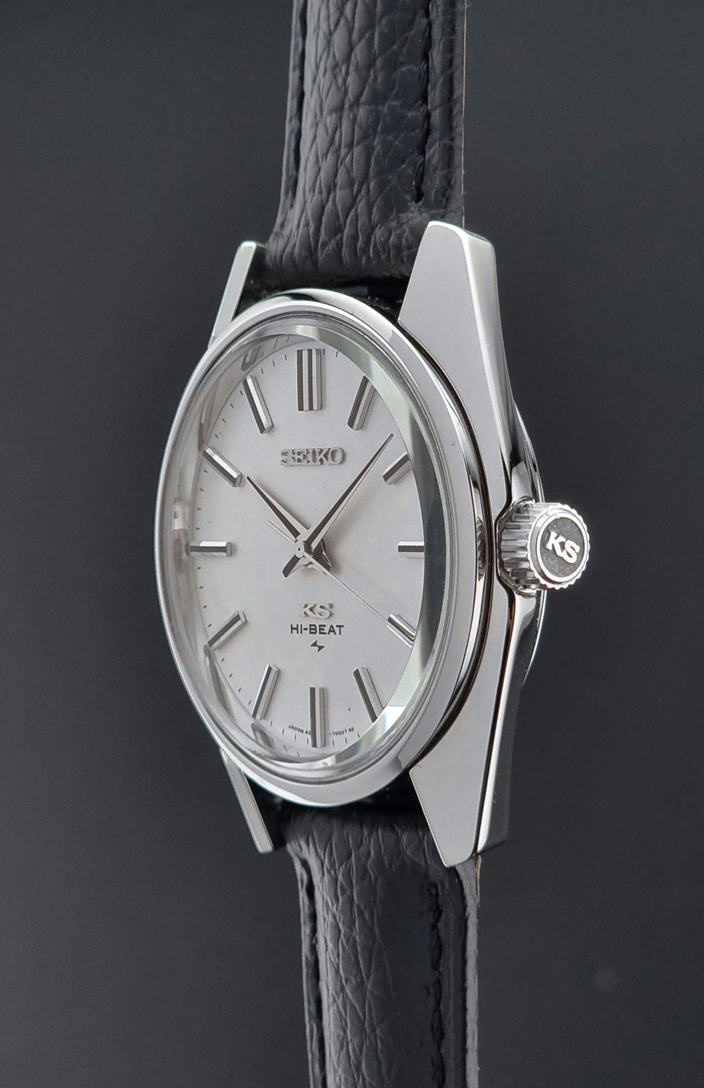 King Seiko 45-7001 watch with silver case and black leather strap on a dark background