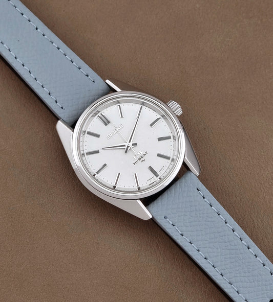 Vintage King Seiko 45-7001 watch with a grey leather strap on a brown background dial