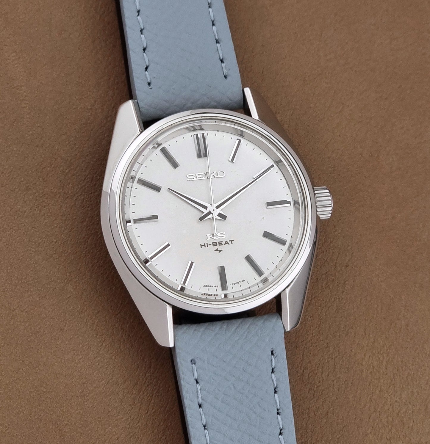 Vintage King Seiko 45-7001 watch with a grey leather strap on a brown background front view