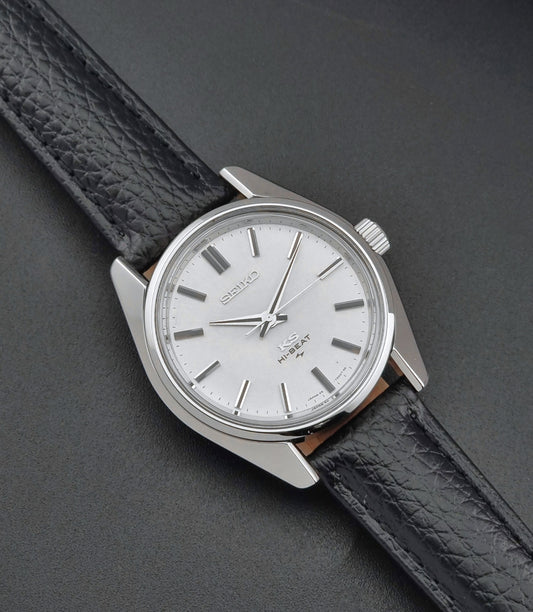 King Seiko 45-7001 watch with a white face and black leather strap on a dark gray background