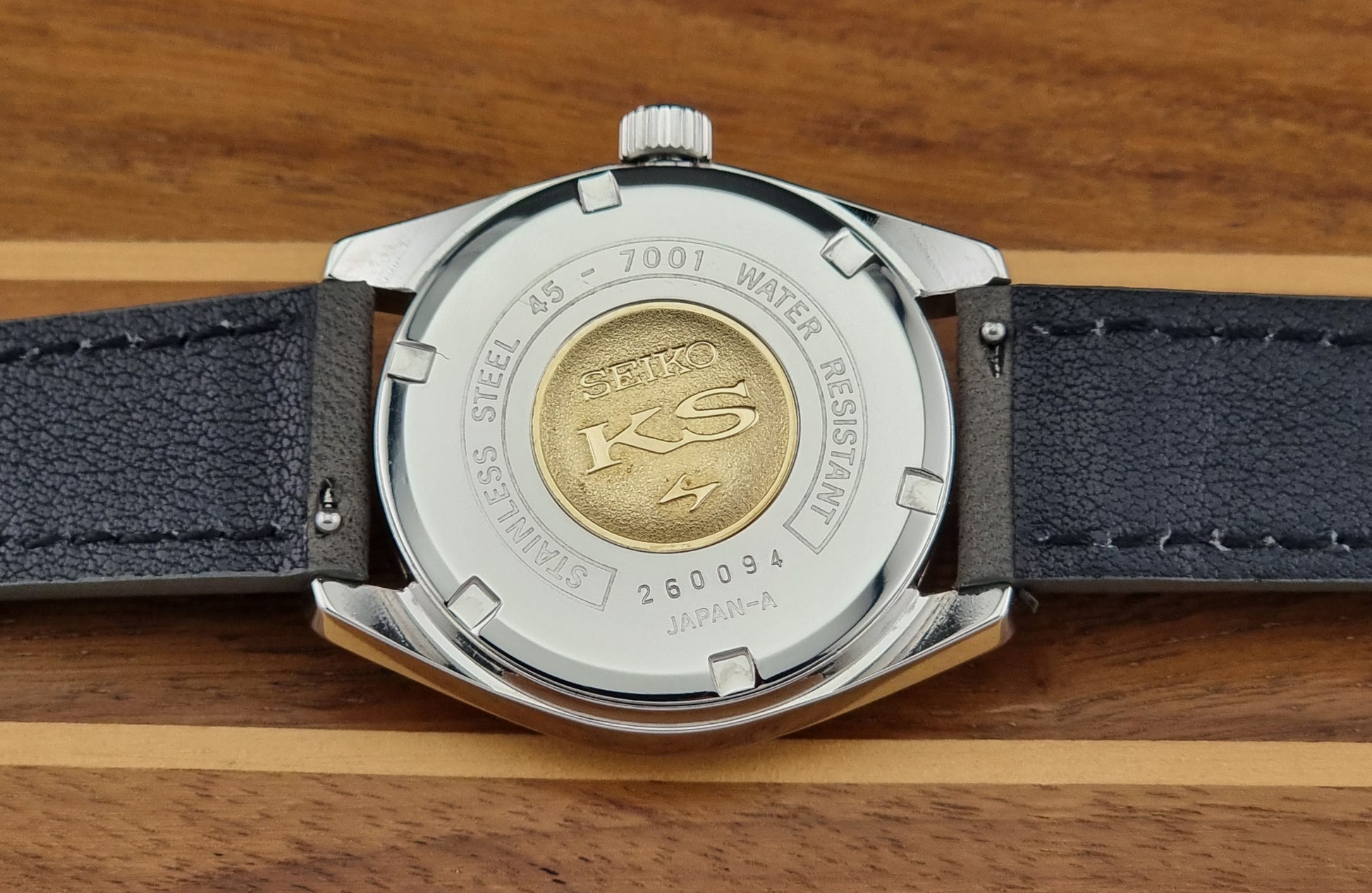 Back view of a watch with Seiko branding on a wooden surface