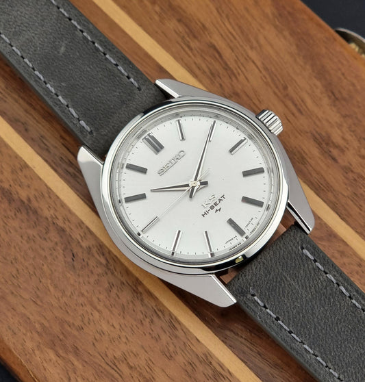 Vintage King Seiko watch with gray strap and silver case on wooden surface