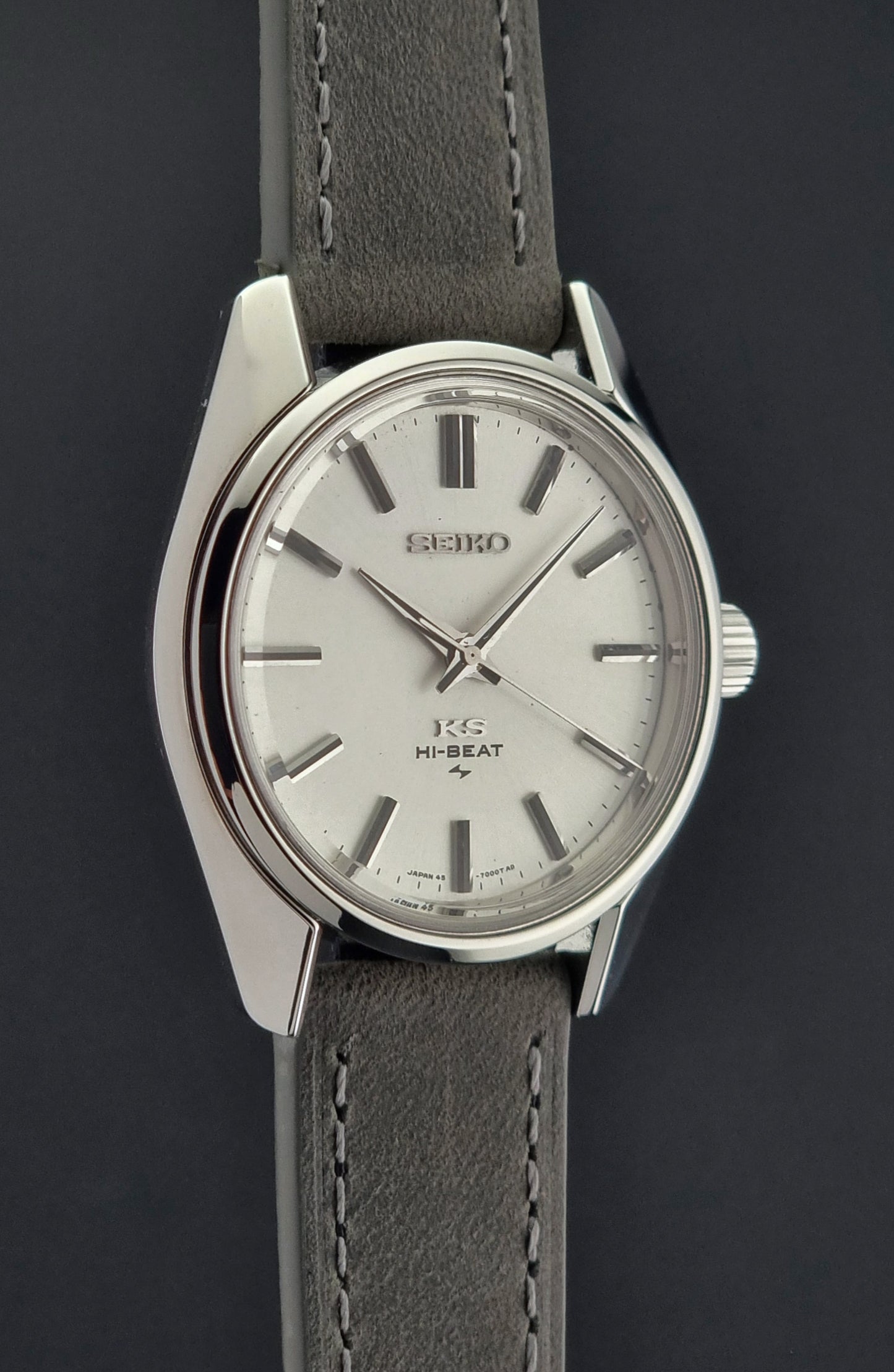 Vintage King Seiko watch with gray leather strap on a dark background