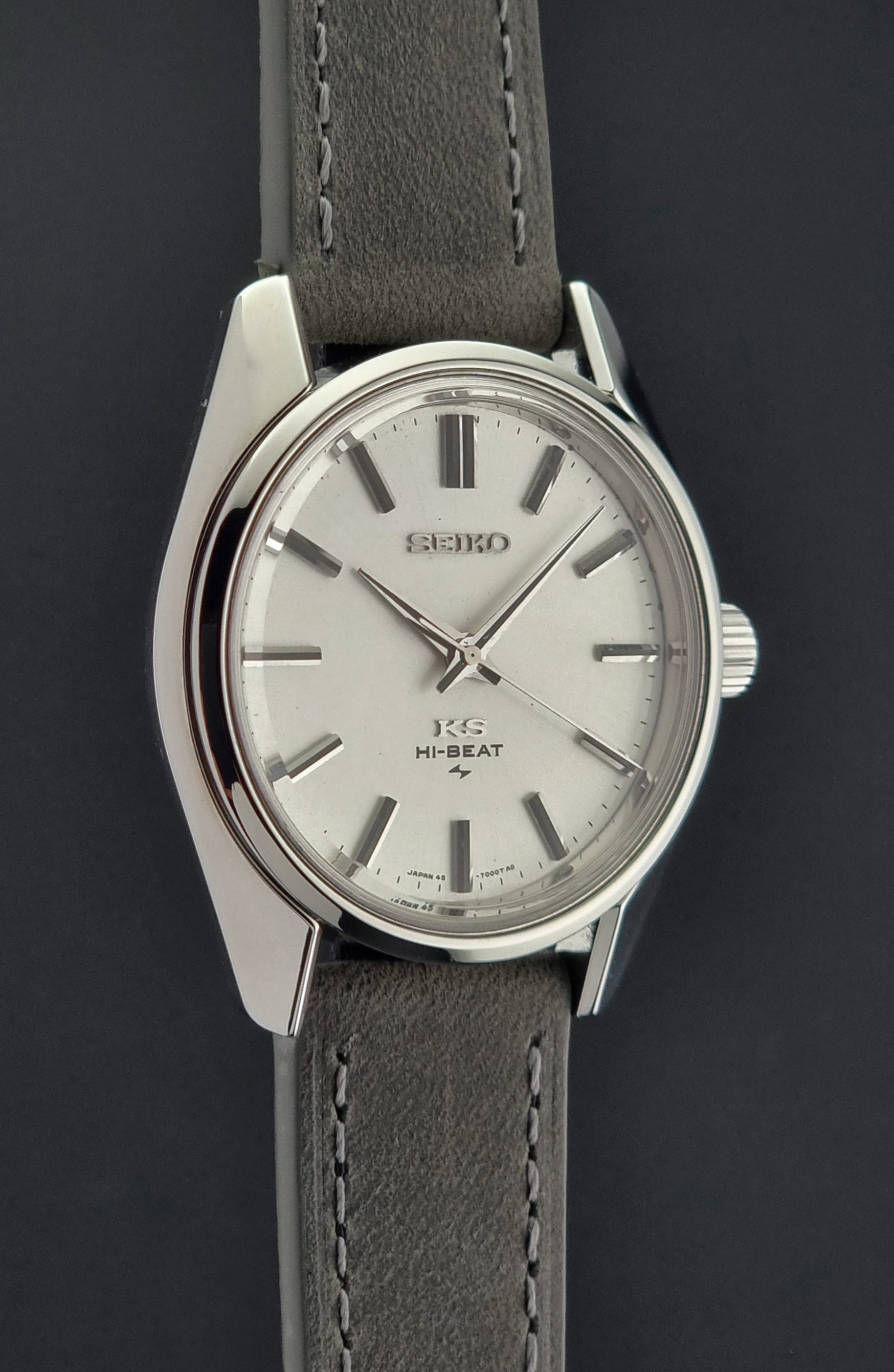 Vintage King Seiko watch with gray leather strap on a dark background