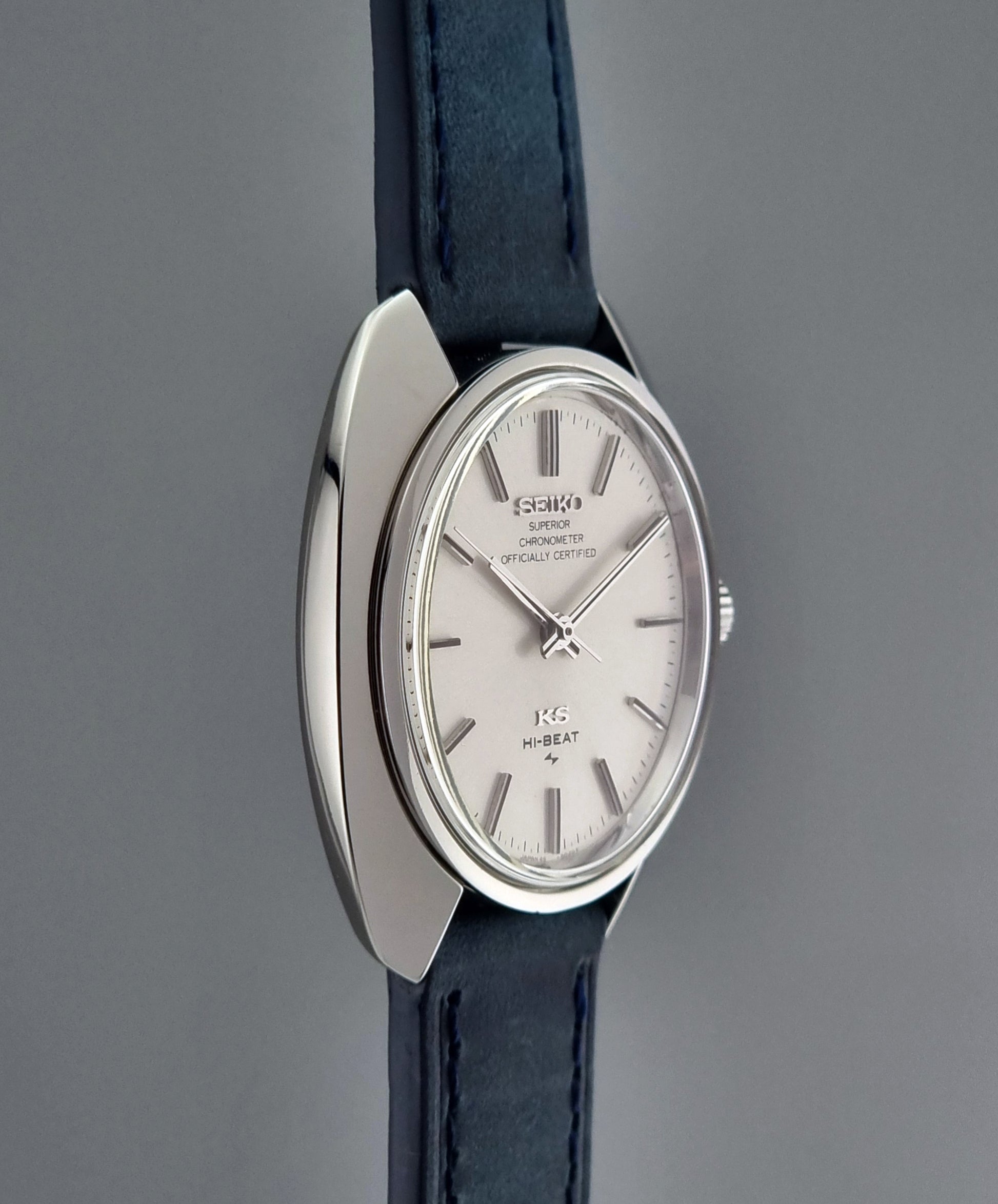 Vintage King Seiko Wristwatch with silver dial and blue strap on a gray background