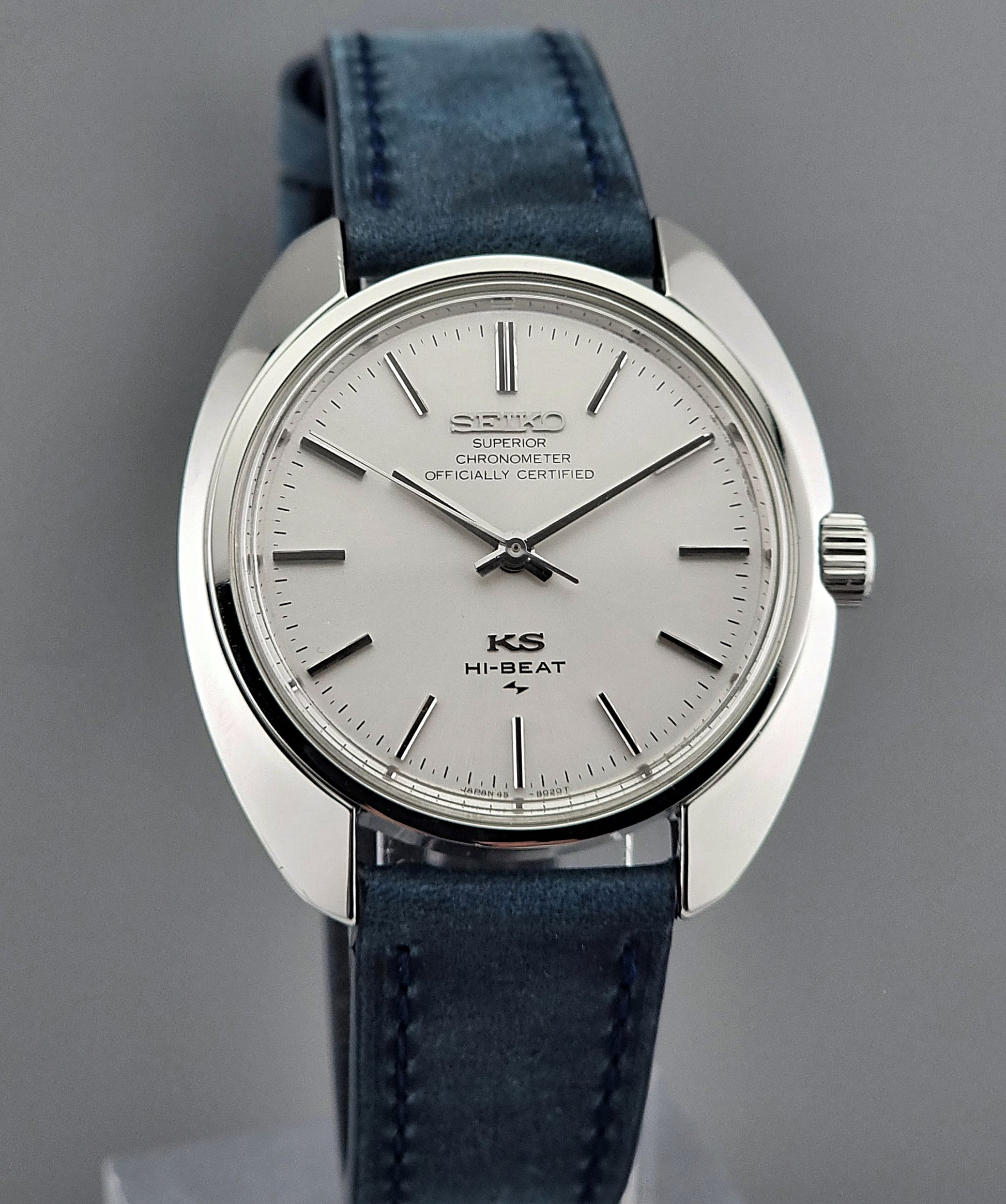 Vintage King Seiko Wristwatch with blue strap and silver case on a gray background