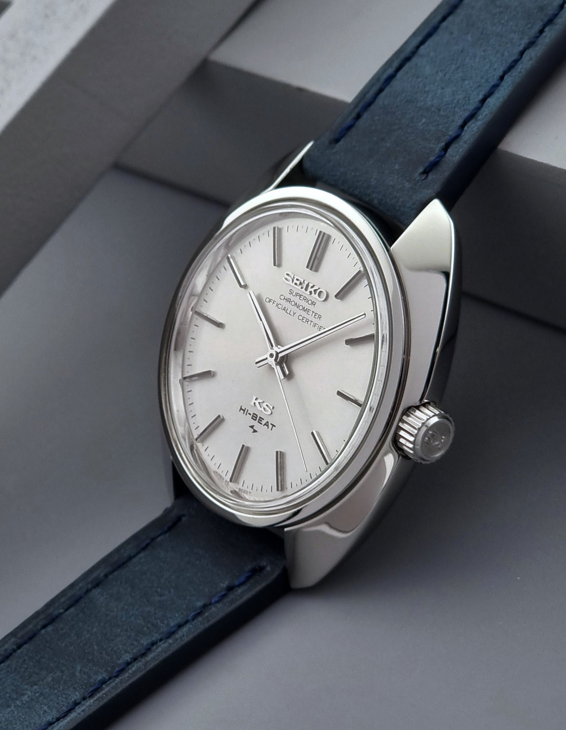 Vintage King Seiko Wristwatch with a blue strap on a gray surface