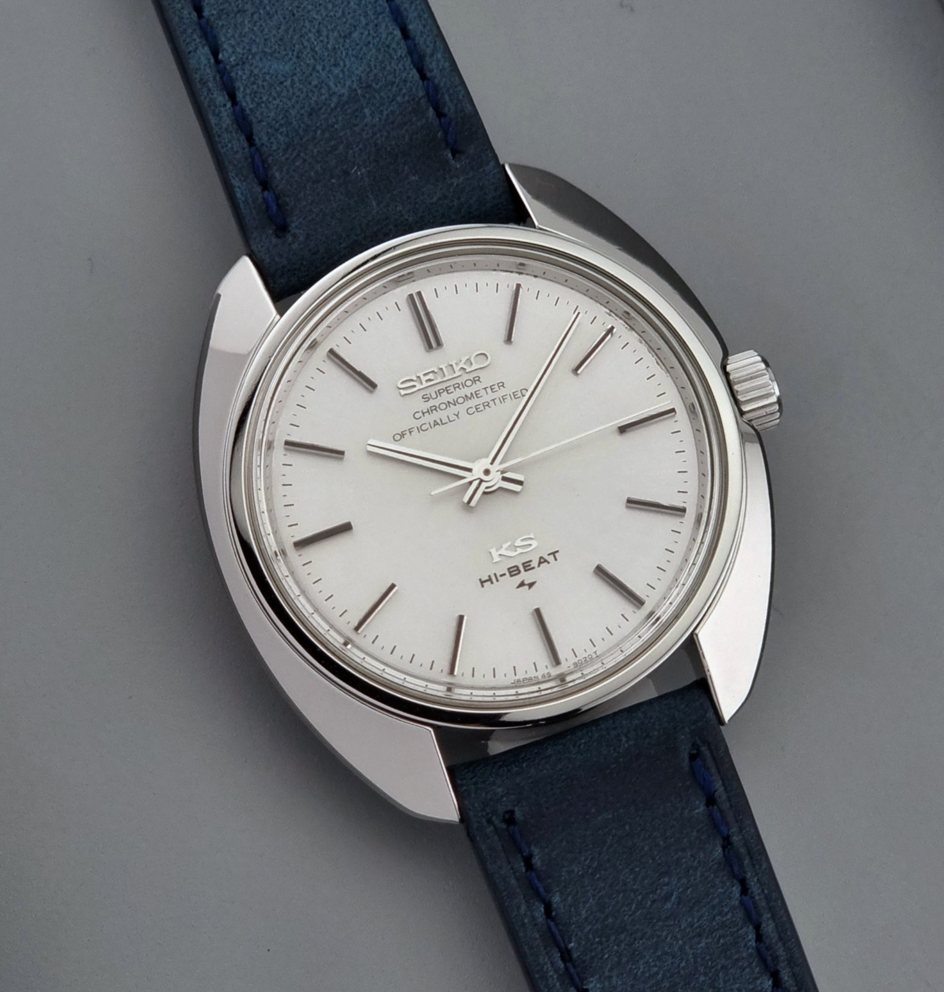 Vintage King Seiko Wristwatch with blue strap on a gray background