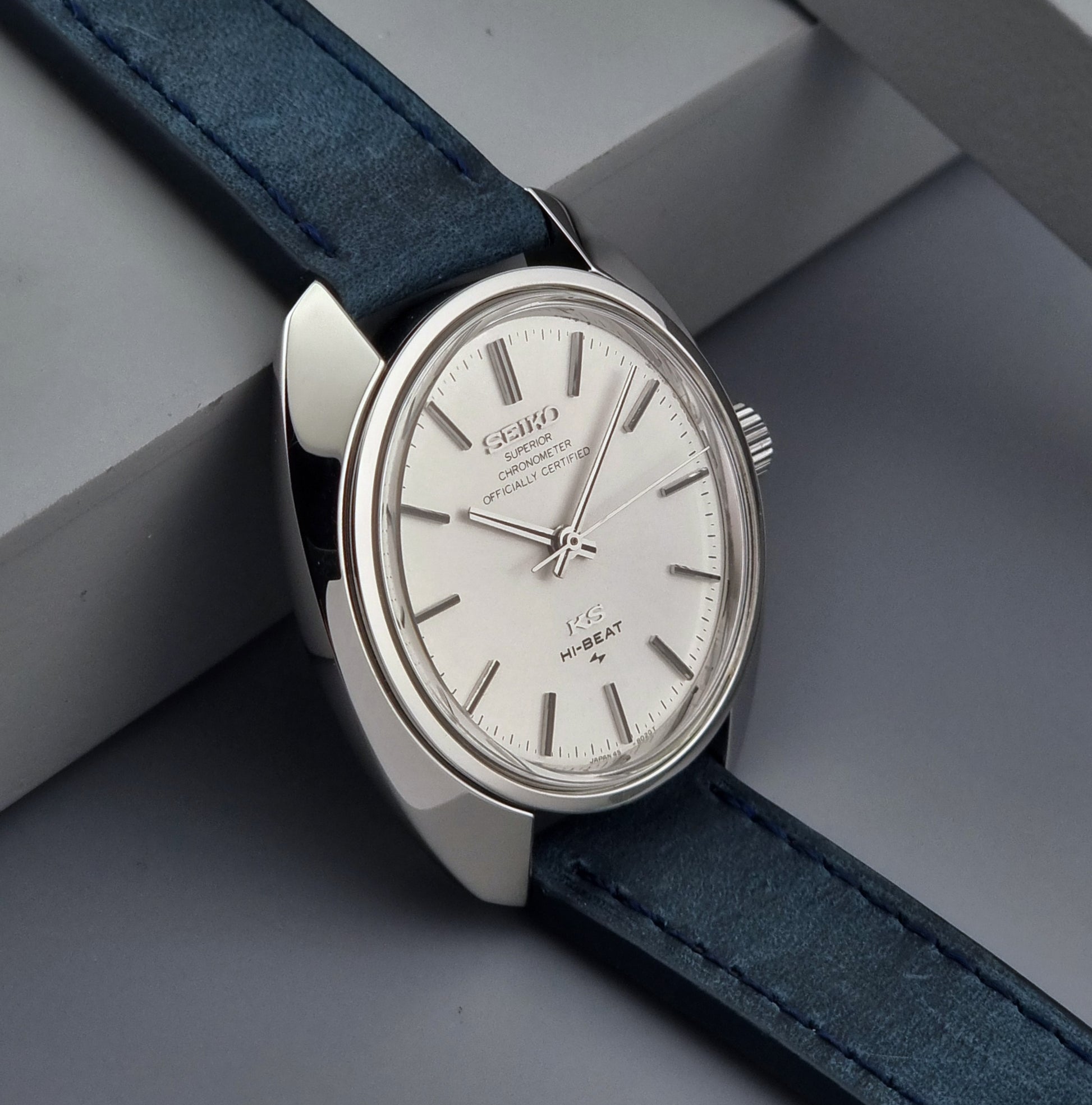 Vintage King Seiko Wristwatch with blue strap on a gray surface