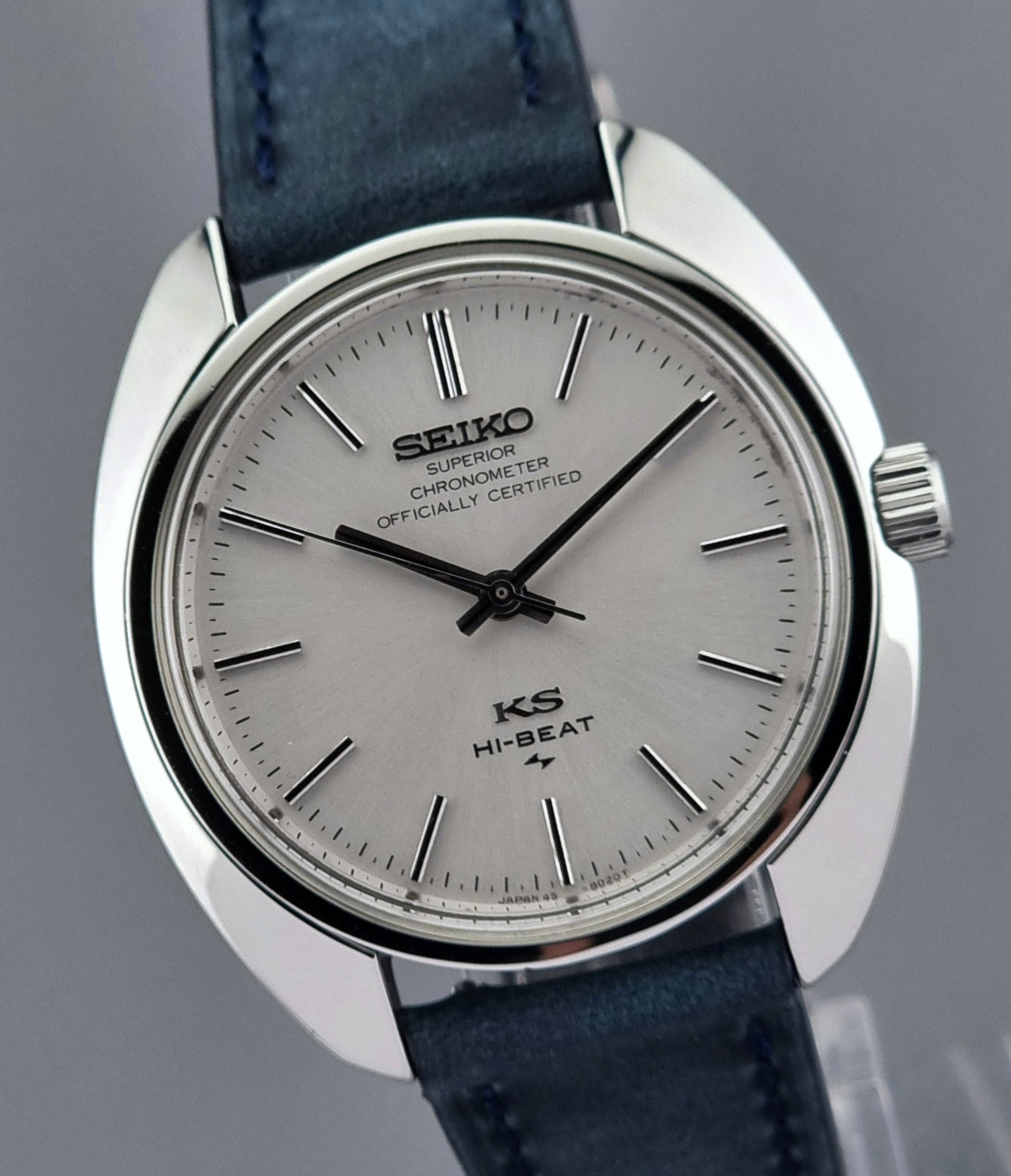 Vintage King Seiko Wristwatch with blue strap on a gray background