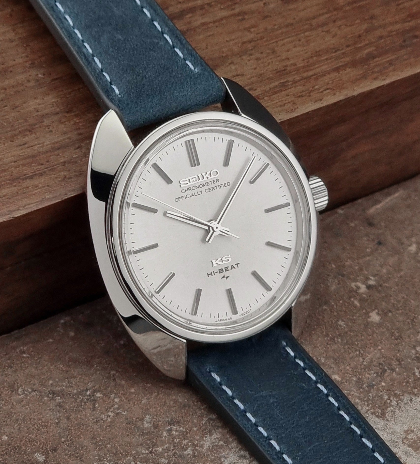 Vintage King Seiko watch with blue leather strap on a wooden surface