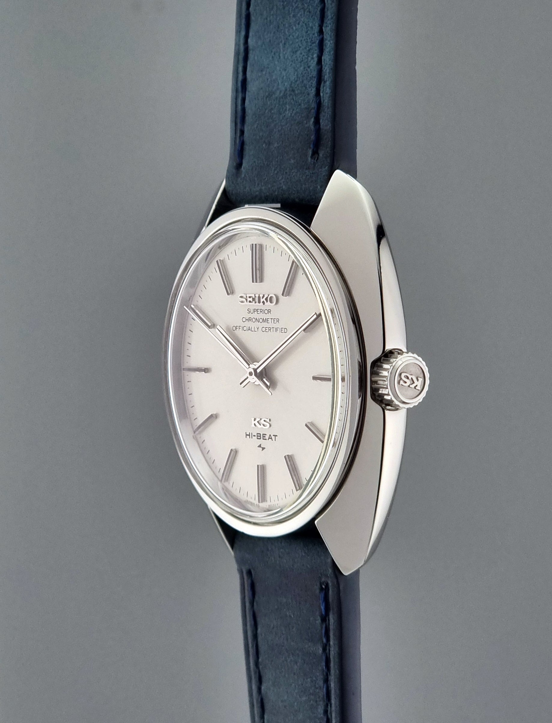 Vintage King Seiko Wristwatch with a silver case and blue strap on a gray background
