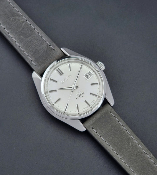 Vintage King Seiko Wristwatch 4502-7000 with a grey strap on a dark background dial