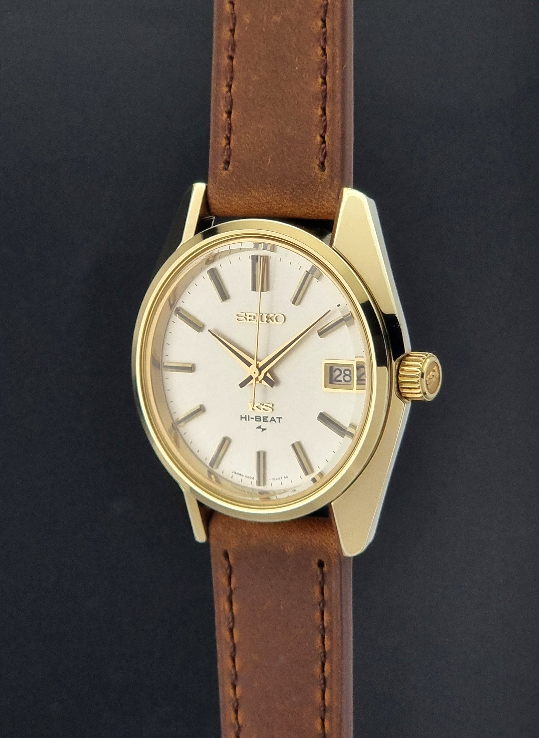 Vintage King Seiko 4502-7001 Wristwatch with brown leather strap on a dark surface crown profile view