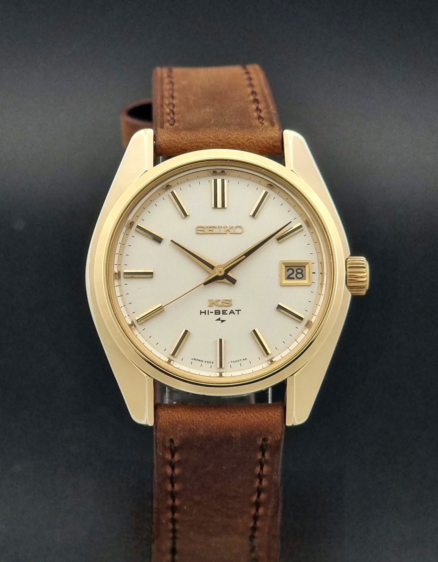 Vintage King Seiko 4502-7001 Wristwatch with brown leather strap on a dark surface close dial view