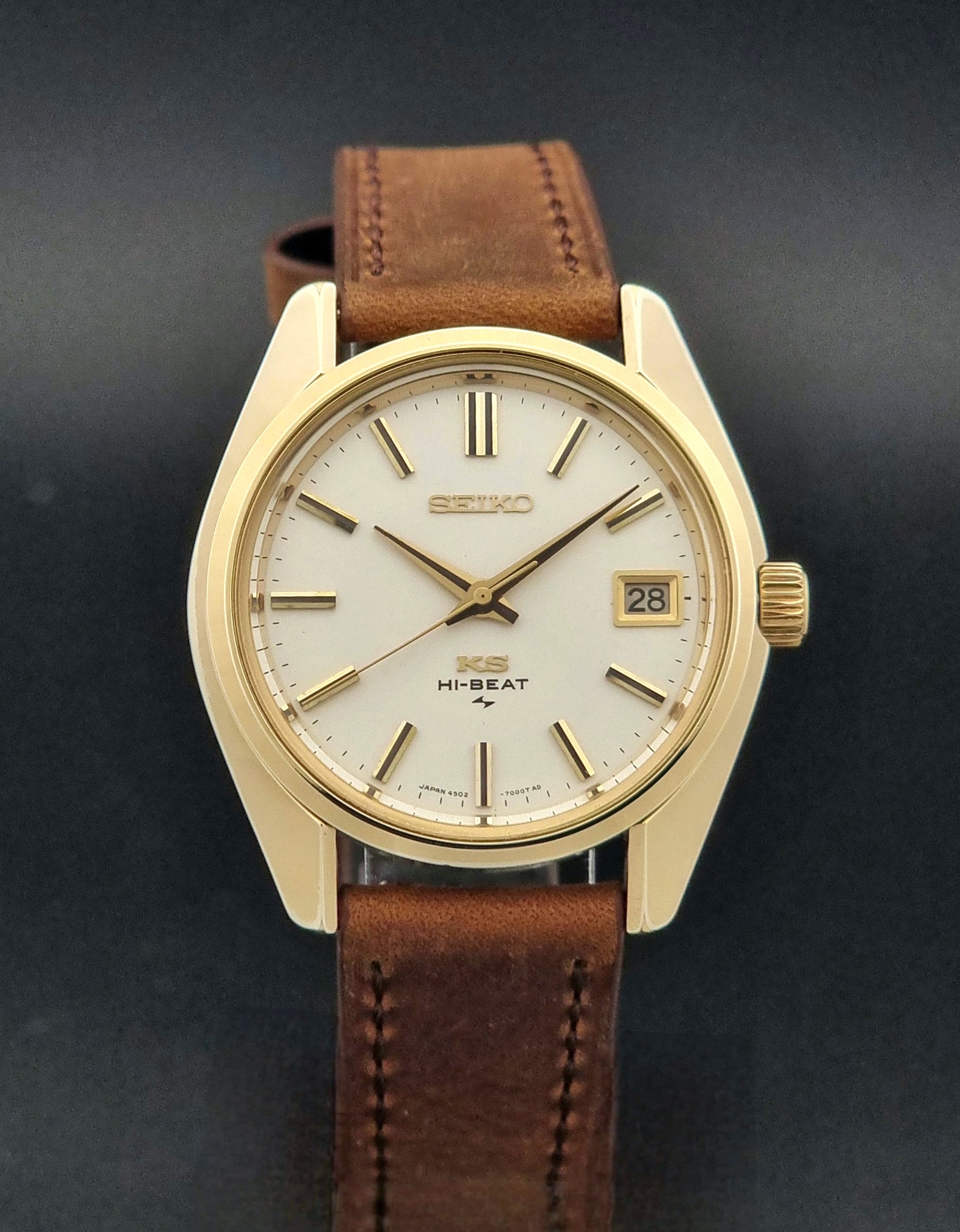 Vintage King Seiko 4502-7001 Wristwatch with brown leather strap on a dark surface close dial view
