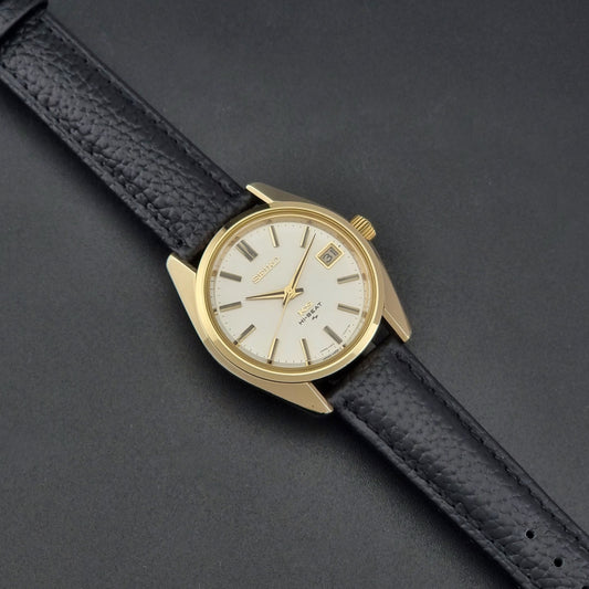 Vintage King Seiko 4502-7001 Wristwatch with black leather strap on a dark gray background dial