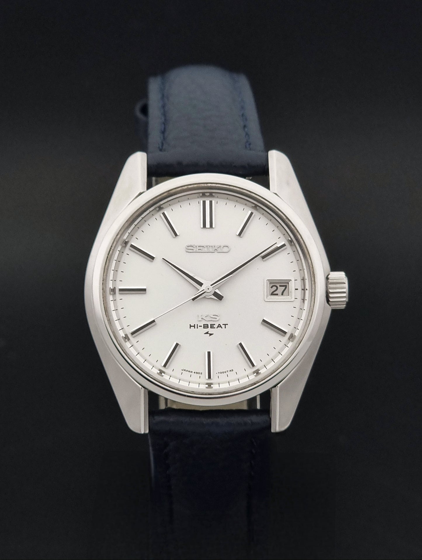 Vintage King Seiko 4502-7001 watch with a blue leather strap on a grey back ground close dial view