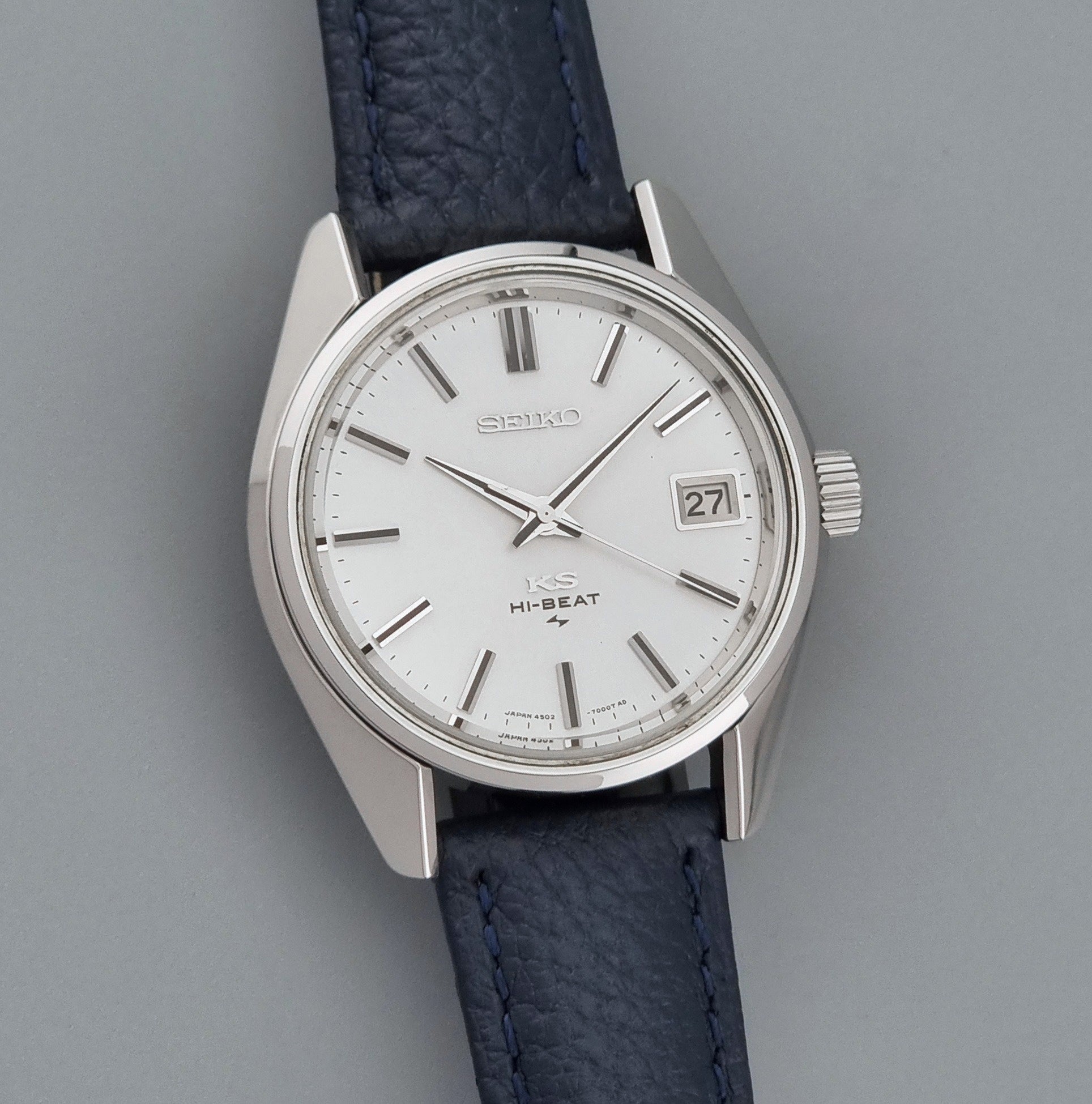 Vintage King Seiko 4502-7001 watch with a blue leather strap on a grey back ground front view
