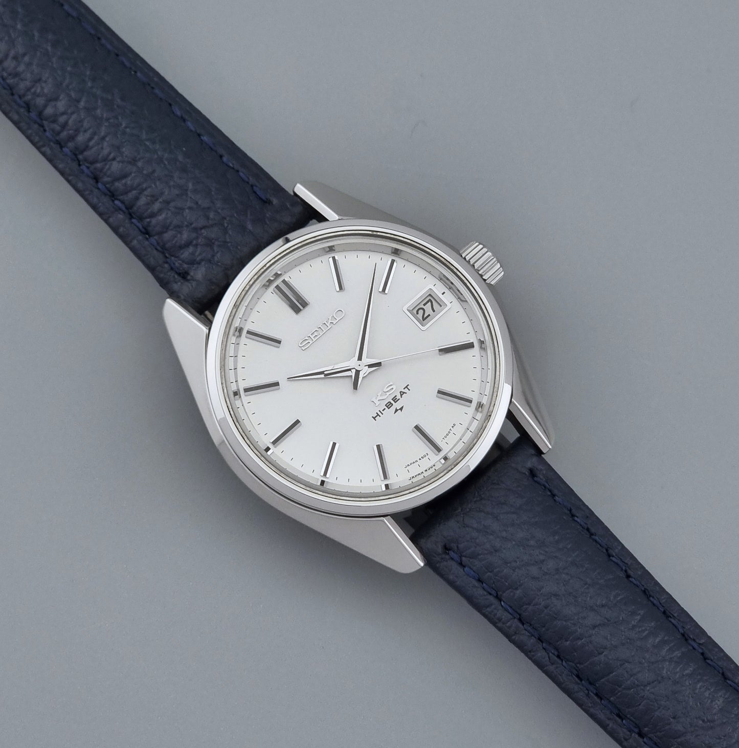 Vintage King Seiko 4502-7001 watch with a blue leather strap on a grey back ground dial