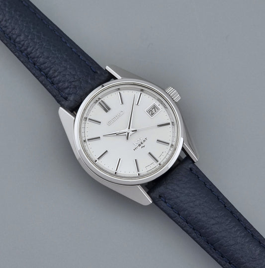 Vintage King Seiko 4502-7001 watch with a blue leather strap on a grey back ground dial