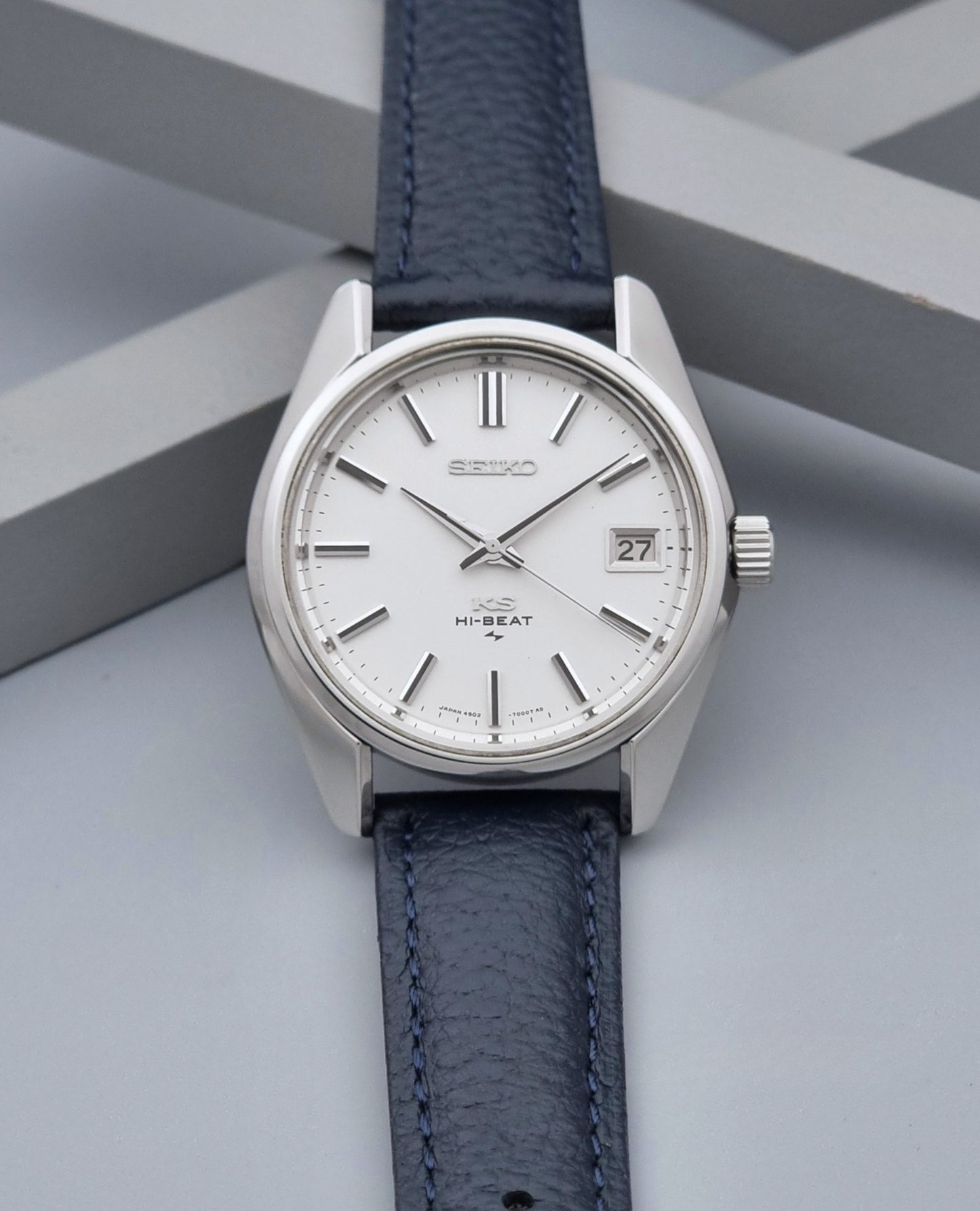 Vintage King Seiko 4502-7001 watch with a blue leather strap on a grey back ground dial view