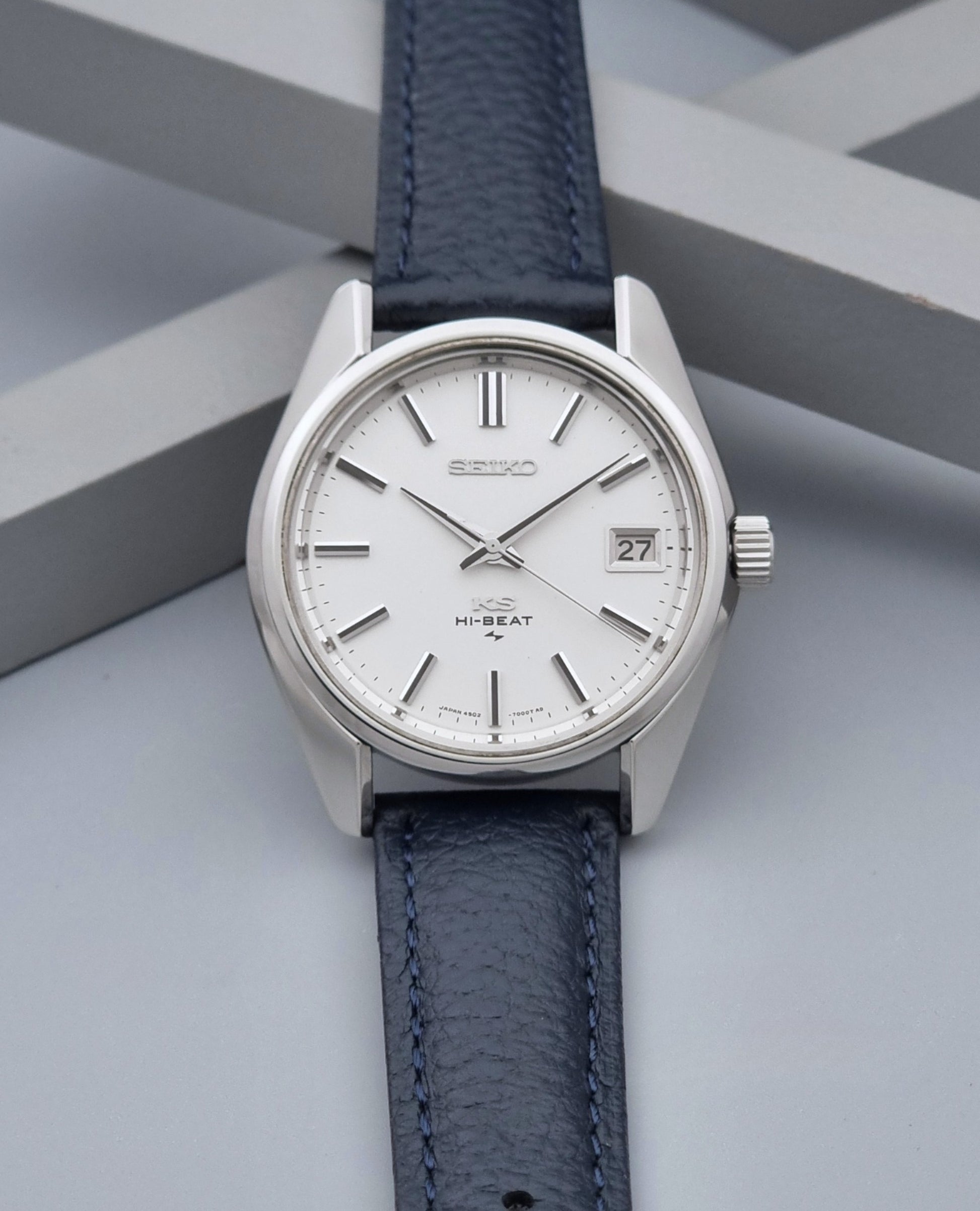 Vintage King Seiko 4502-7001 watch with a blue leather strap on a grey back ground dial view
