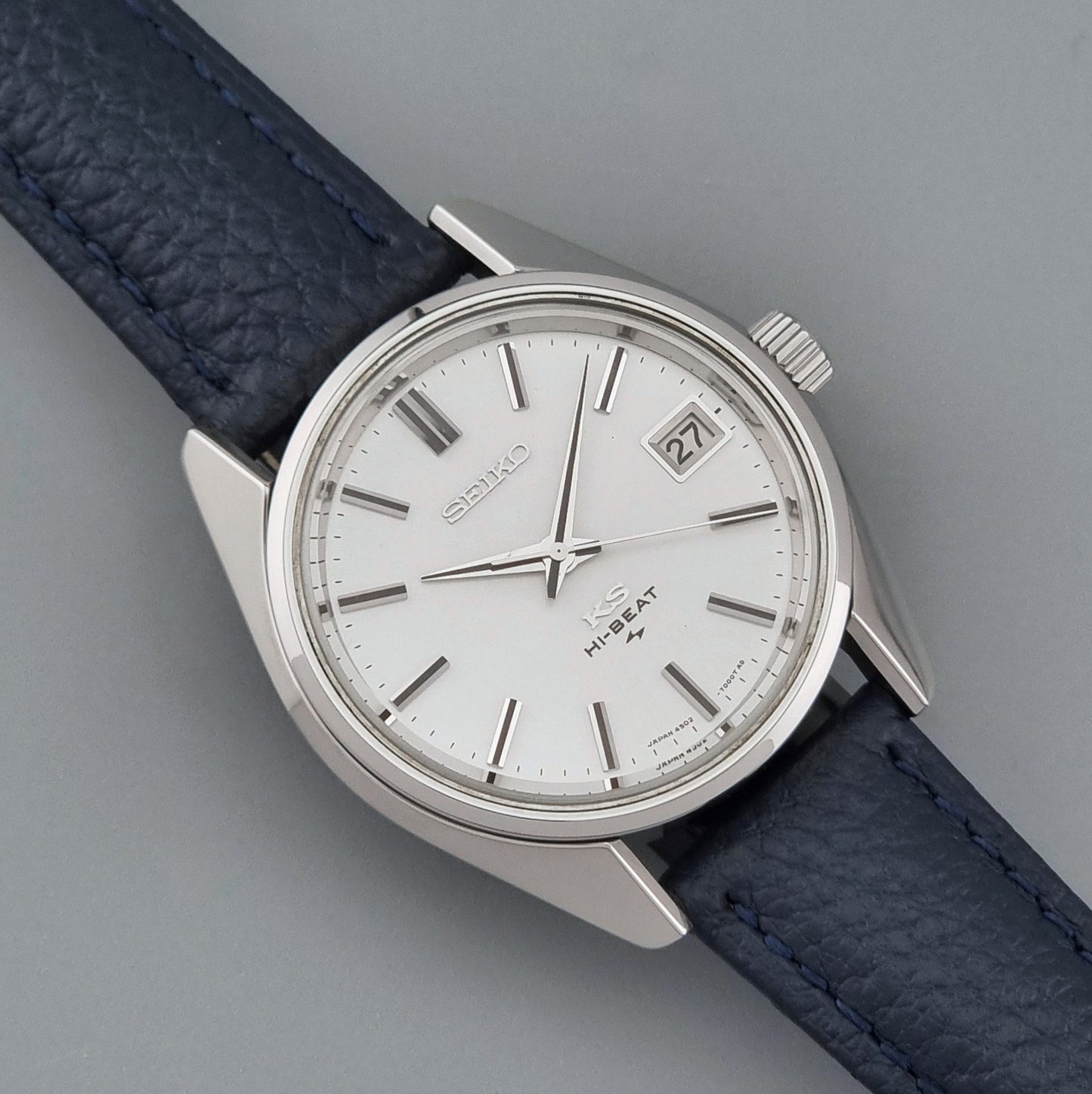 Vintage King Seiko 4502-7001 watch with a blue leather strap on a grey back ground close up dial view