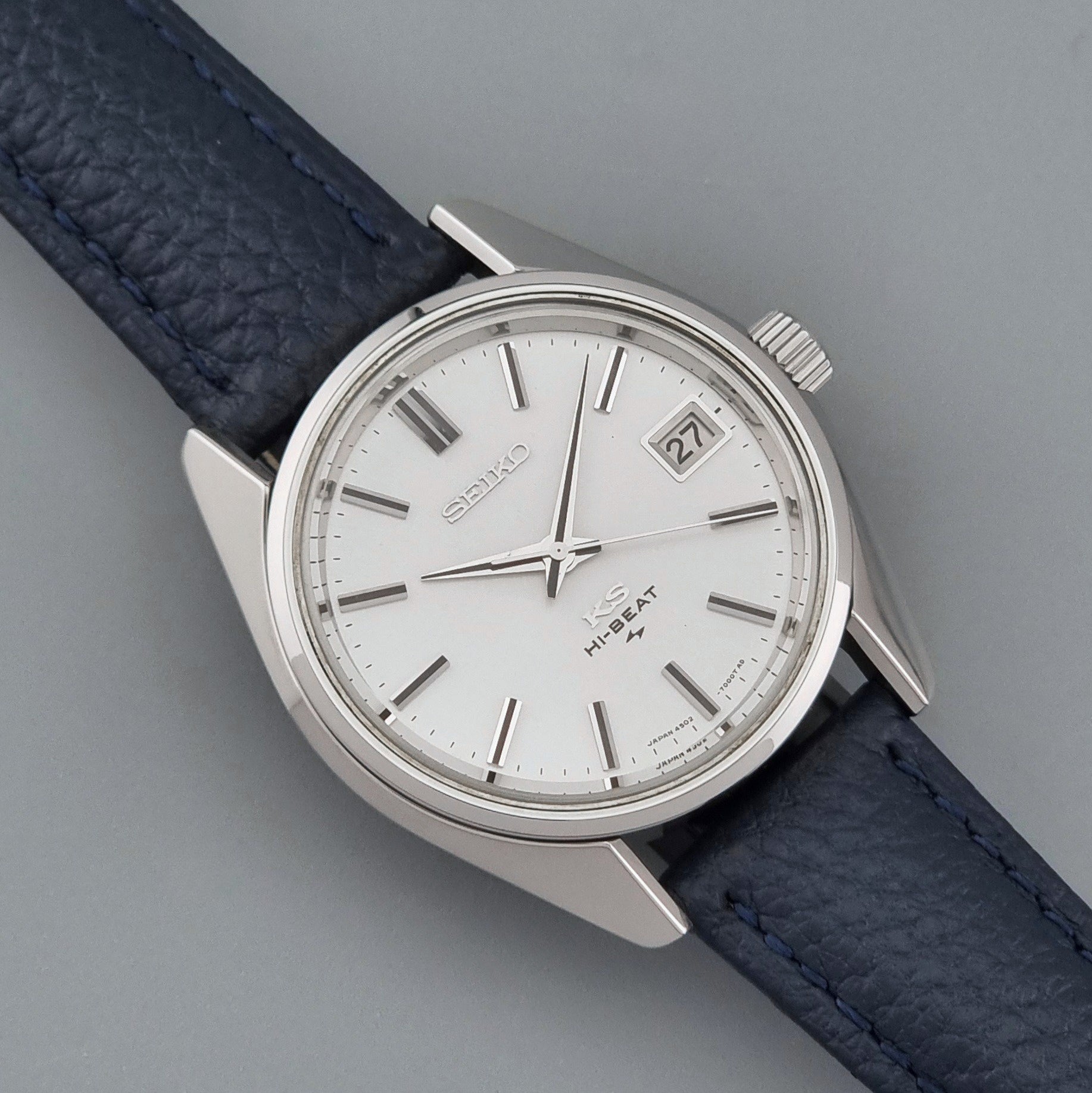 Vintage King Seiko 4502-7001 watch with a blue leather strap on a grey back ground close up dial view
