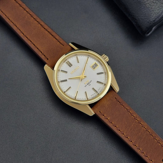 Vintage King Seiko Wristwatch 4502-7001 brown leather strap on a dark gray background dial