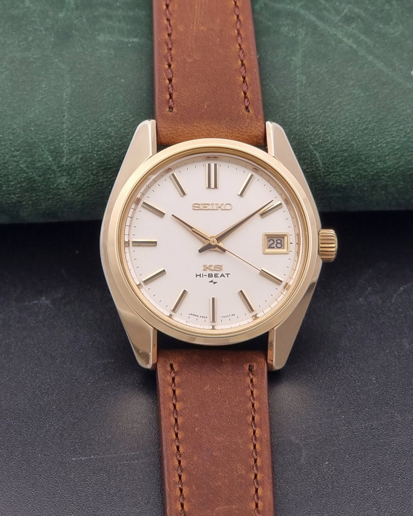Vintage King Seiko 4502-7001 Wristwatch with brown leather strap on a dark surface dial view