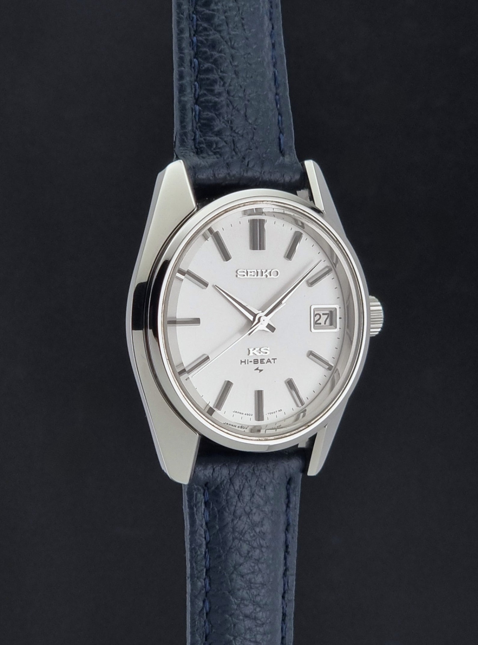 Vintage King Seiko 4502-7001 watch with a blue leather strap on a grey back ground side profile view