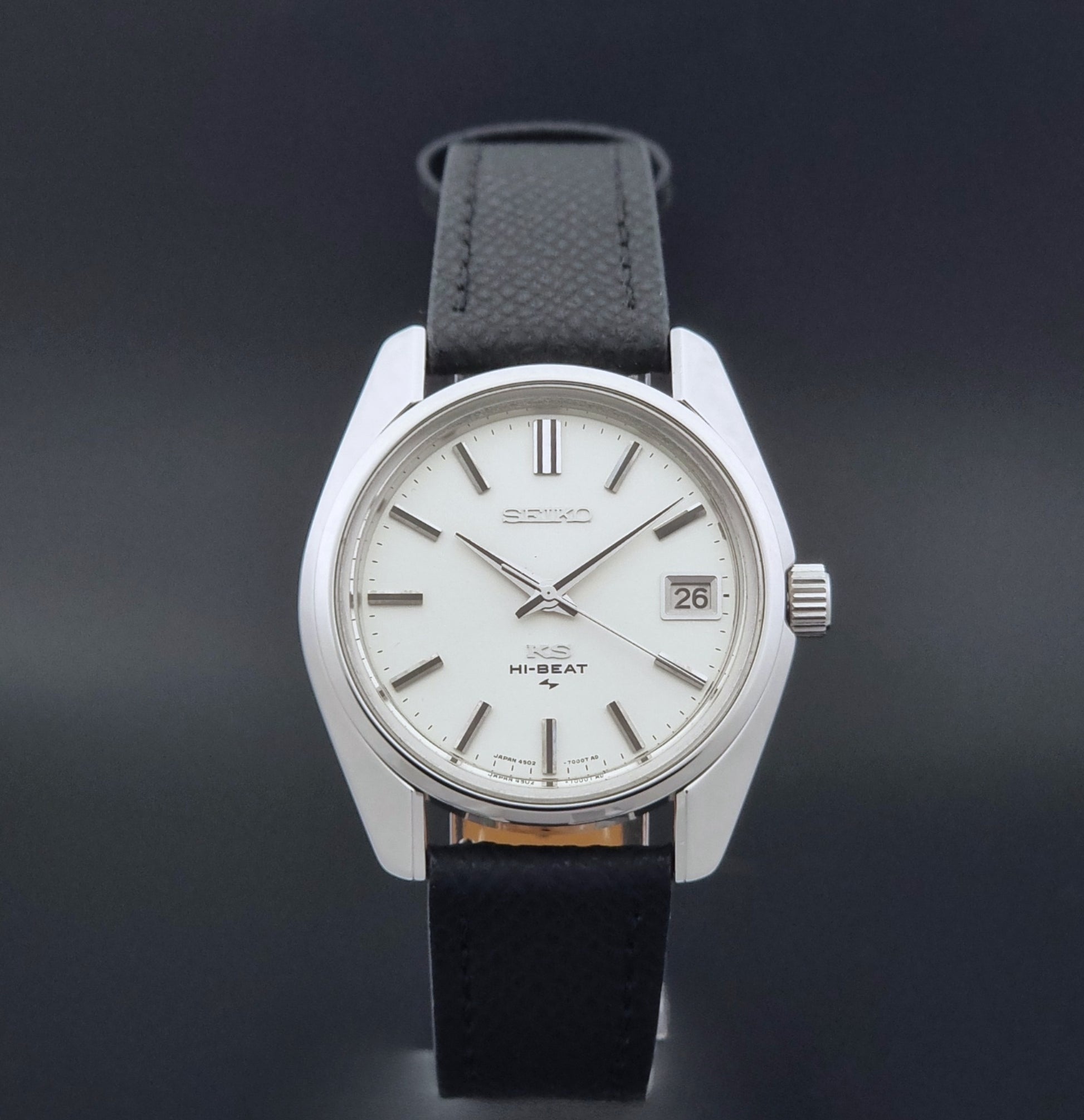 Vintage King Seiko 4502-7001 watch with black strap and silver case on a dark gray background close dial view