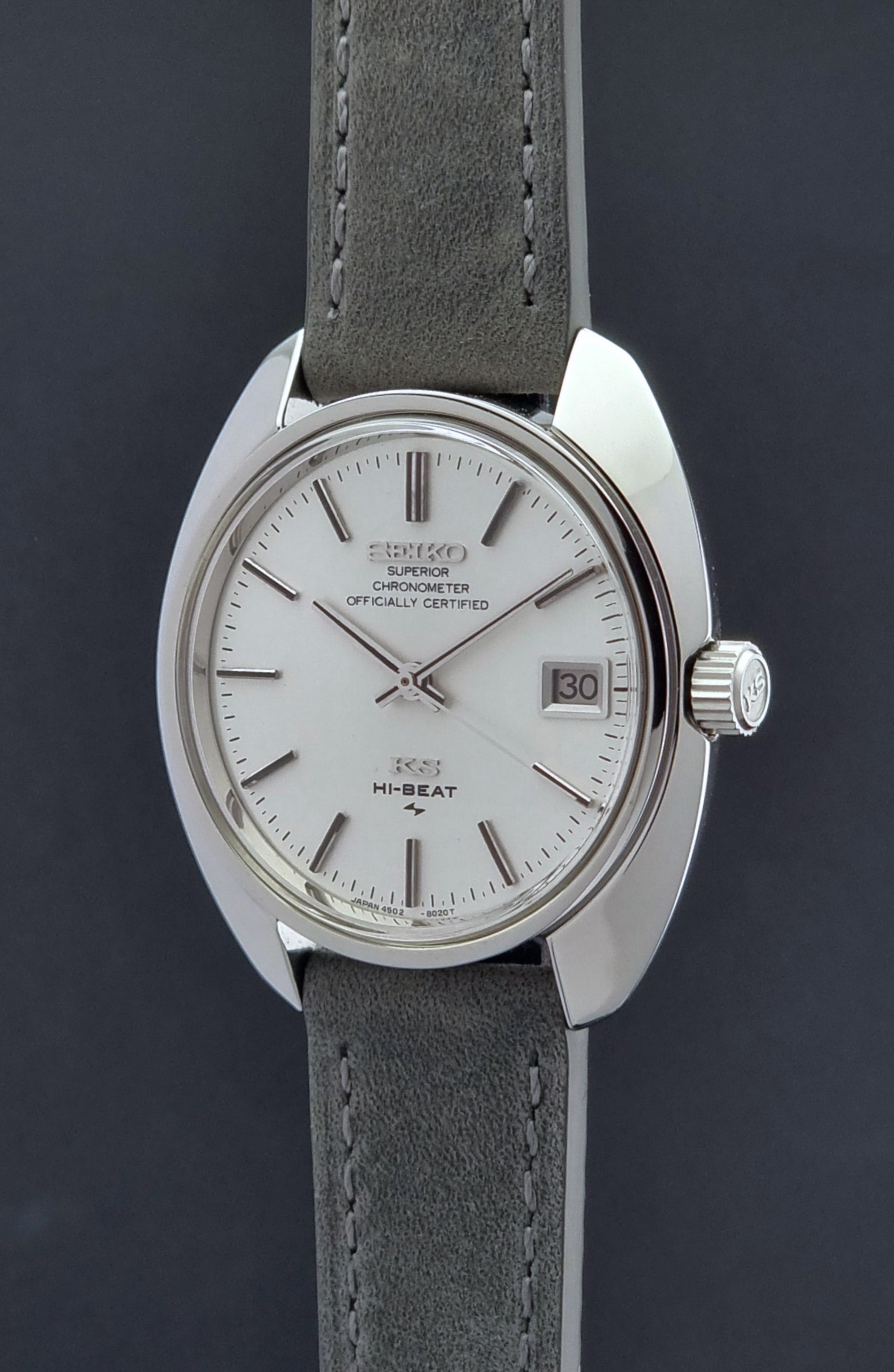 King Seiko Watch Hi-Beat 4502-8010 with gray strap and silver dial on a dark background crown side profile