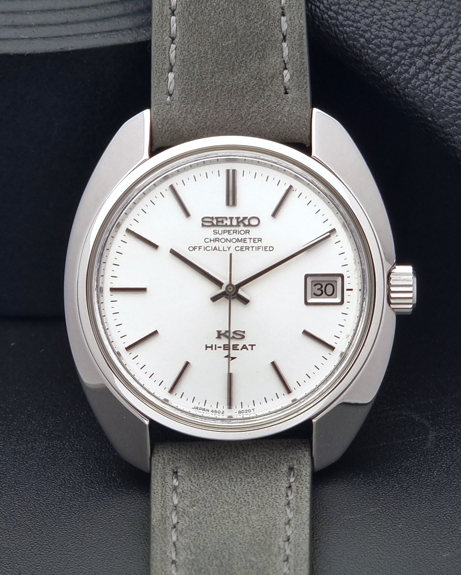 King Seiko Watch Hi-Beat 4502-8010 with gray strap and silver dial on a dark background close up of the dial