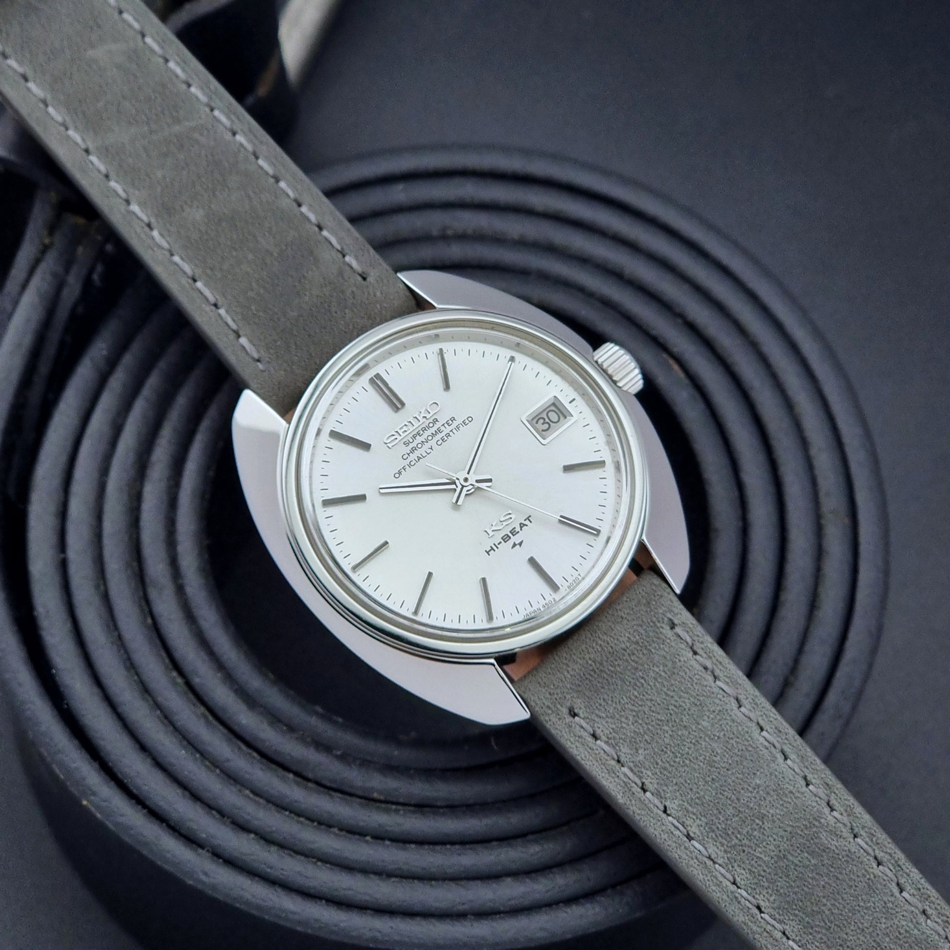 King Seiko Watch Hi-Beat 4502-8010 with gray strap on a textured dark background