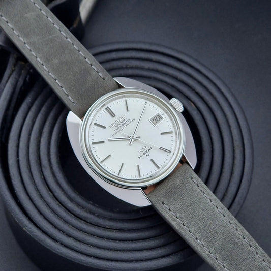 King Seiko Watch Hi-Beat 4502-8010 with gray strap on a textured dark background