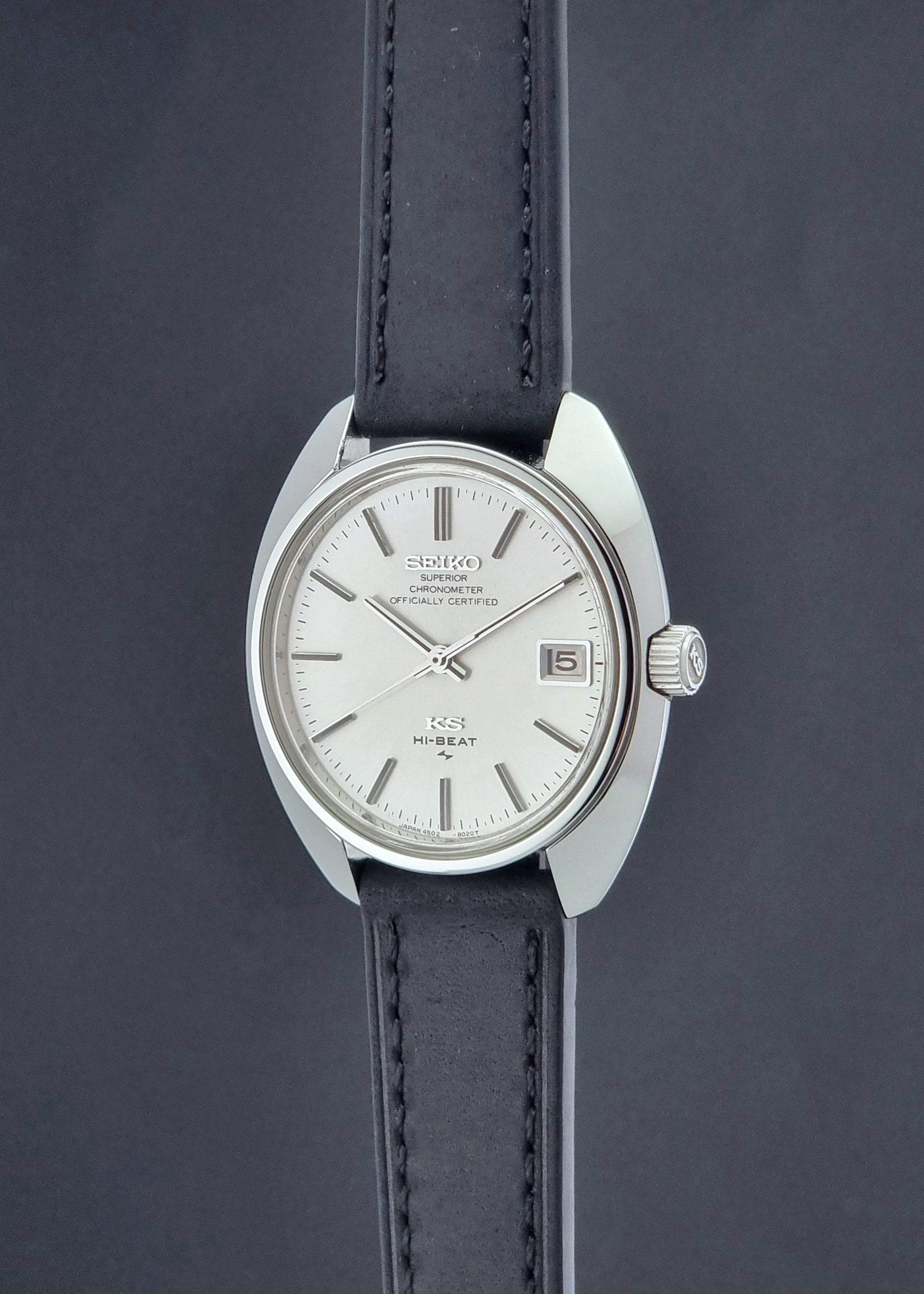 Vintage King Seiko Watch 4502-8010 with a black leather strap on a dark background crown profile view
