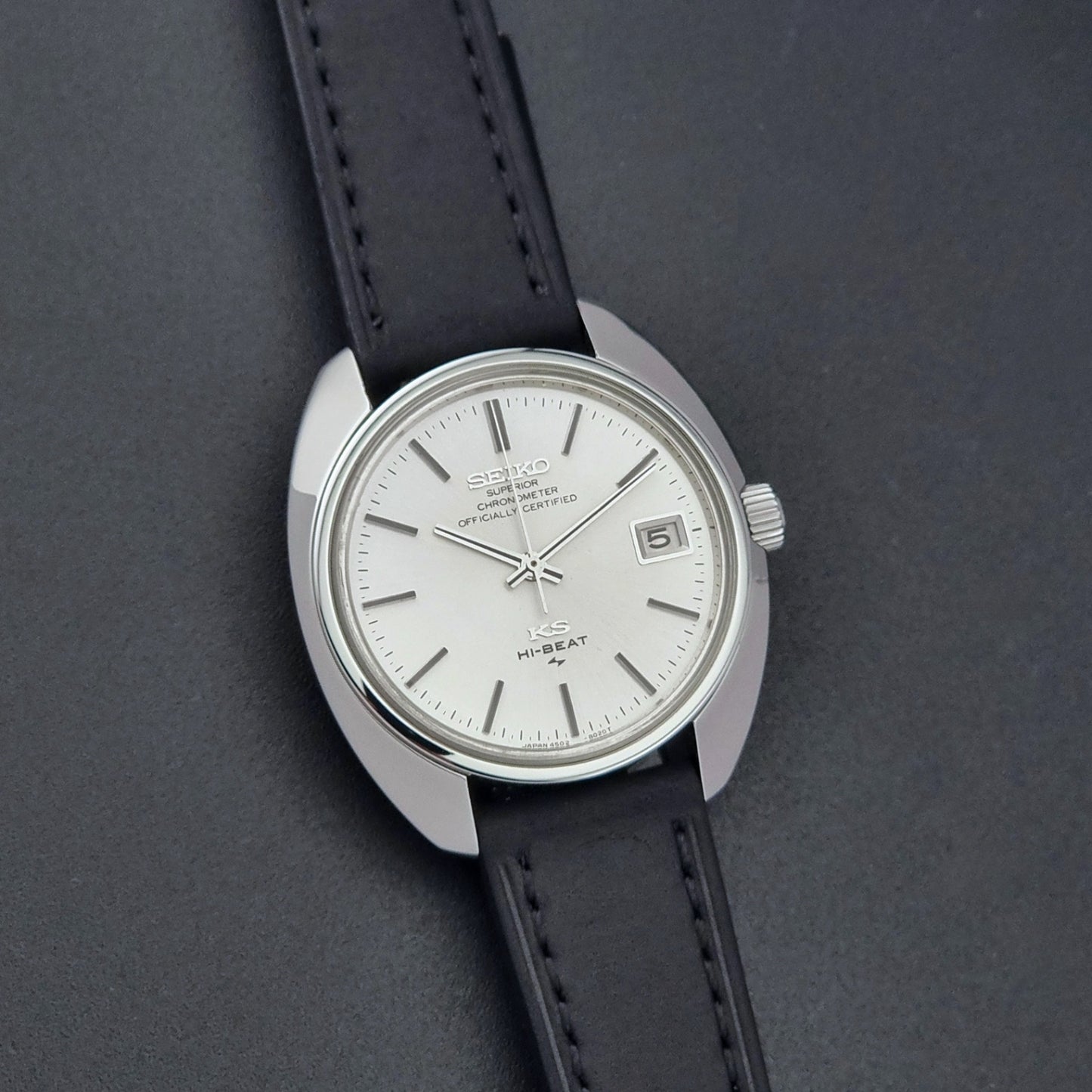 Vintage King Seiko Watch 4502-8010 with a black leather strap on a dark background front view