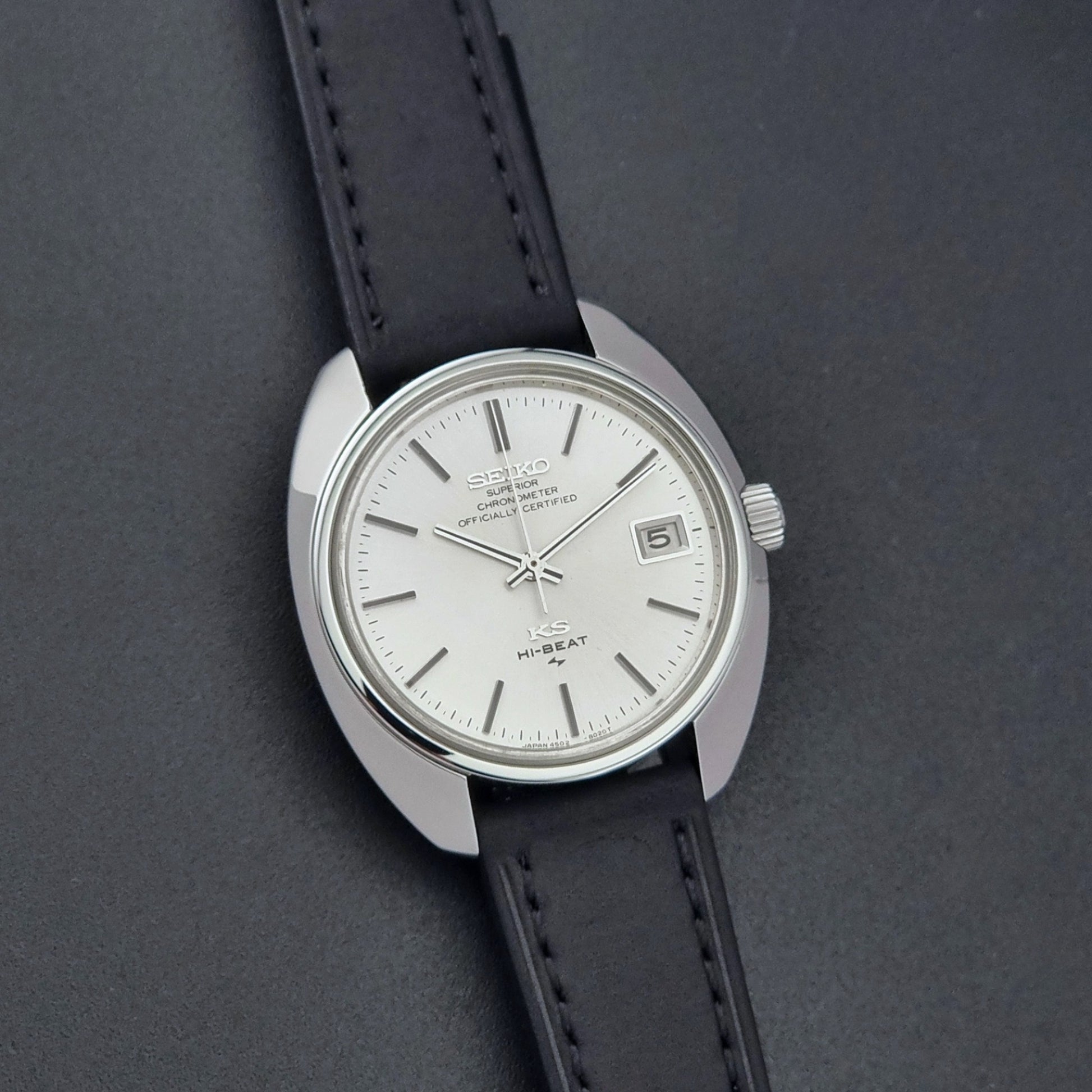 Vintage King Seiko Watch 4502-8010 with a black leather strap on a dark background front view