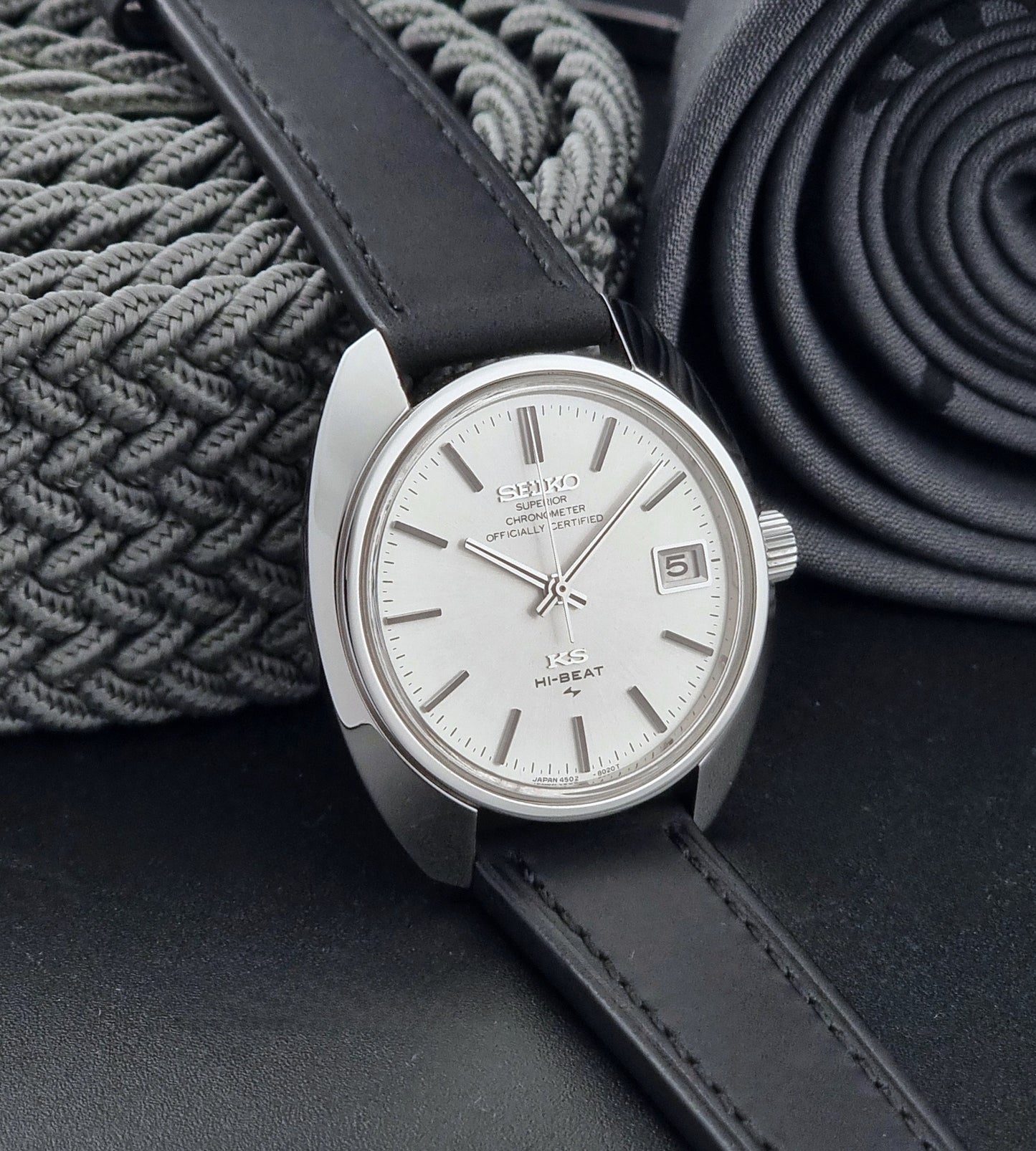 Vintage King Seiko Watch 4502-8010 with a black leather strap on a dark background side view