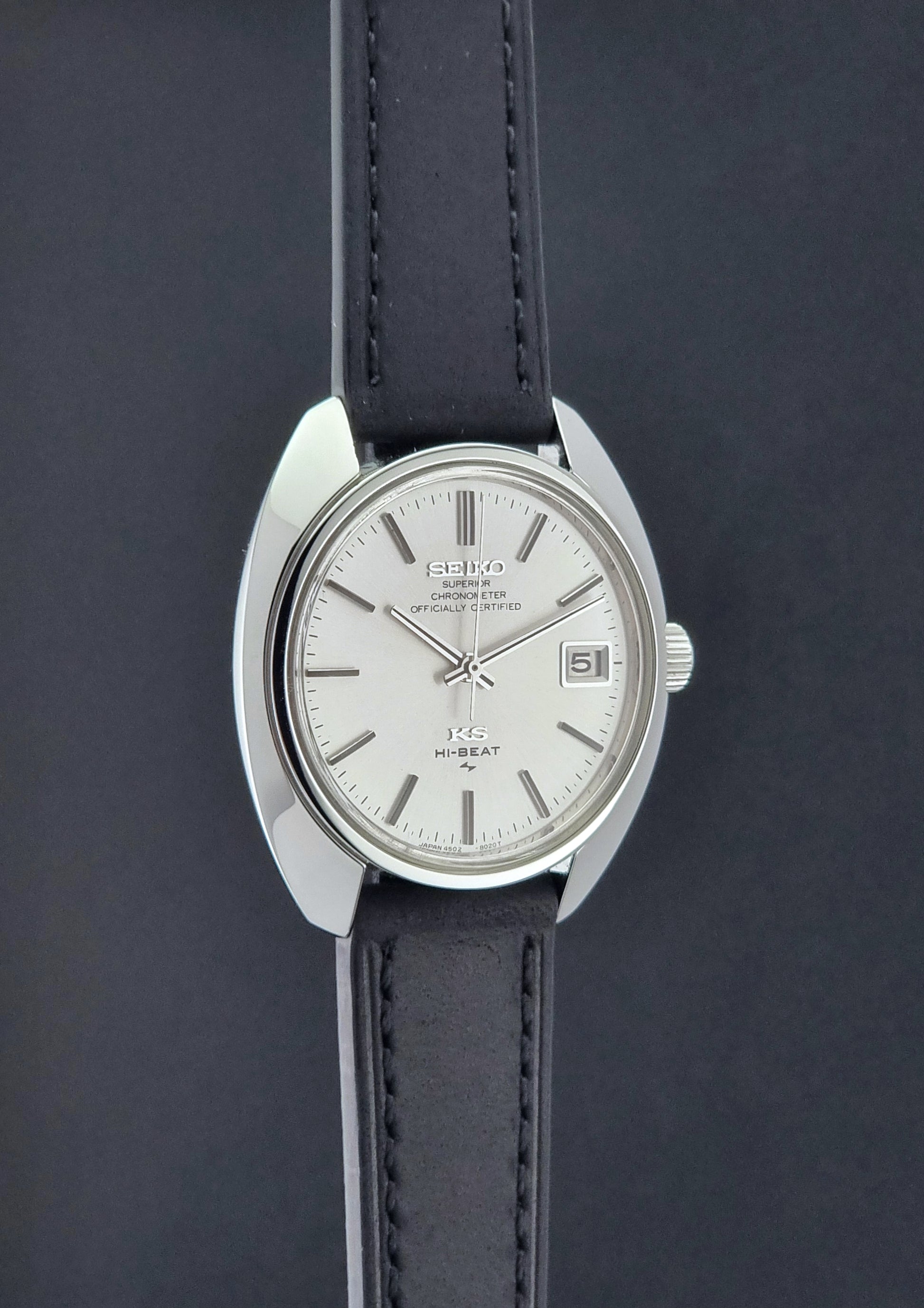 Vintage King Seiko Watch 4502-8010 with a black leather strap on a dark background side profile view