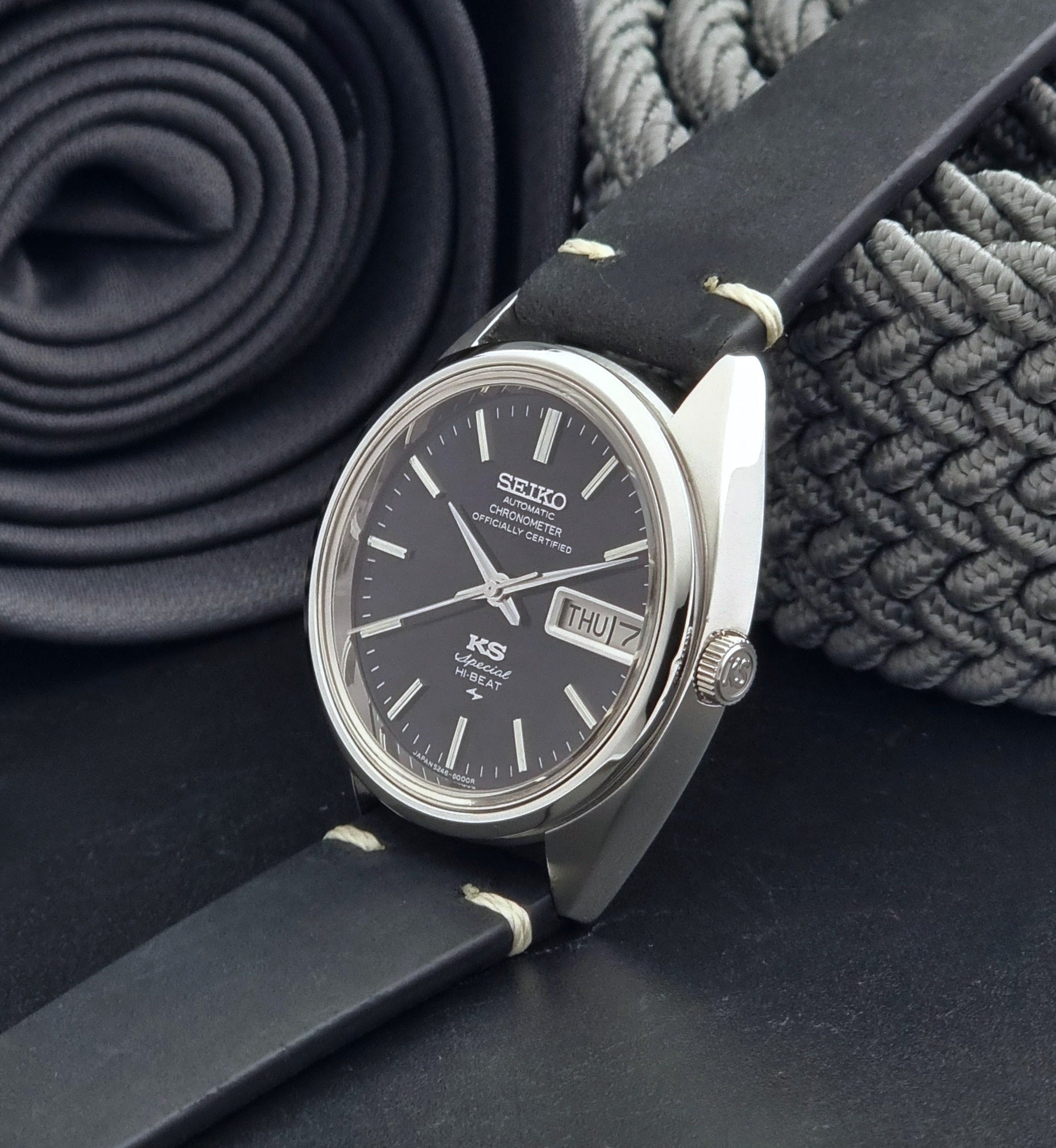 Vintage King Seiko Watch Special 5246-6000 with black leather strap on a dark gray background crown view