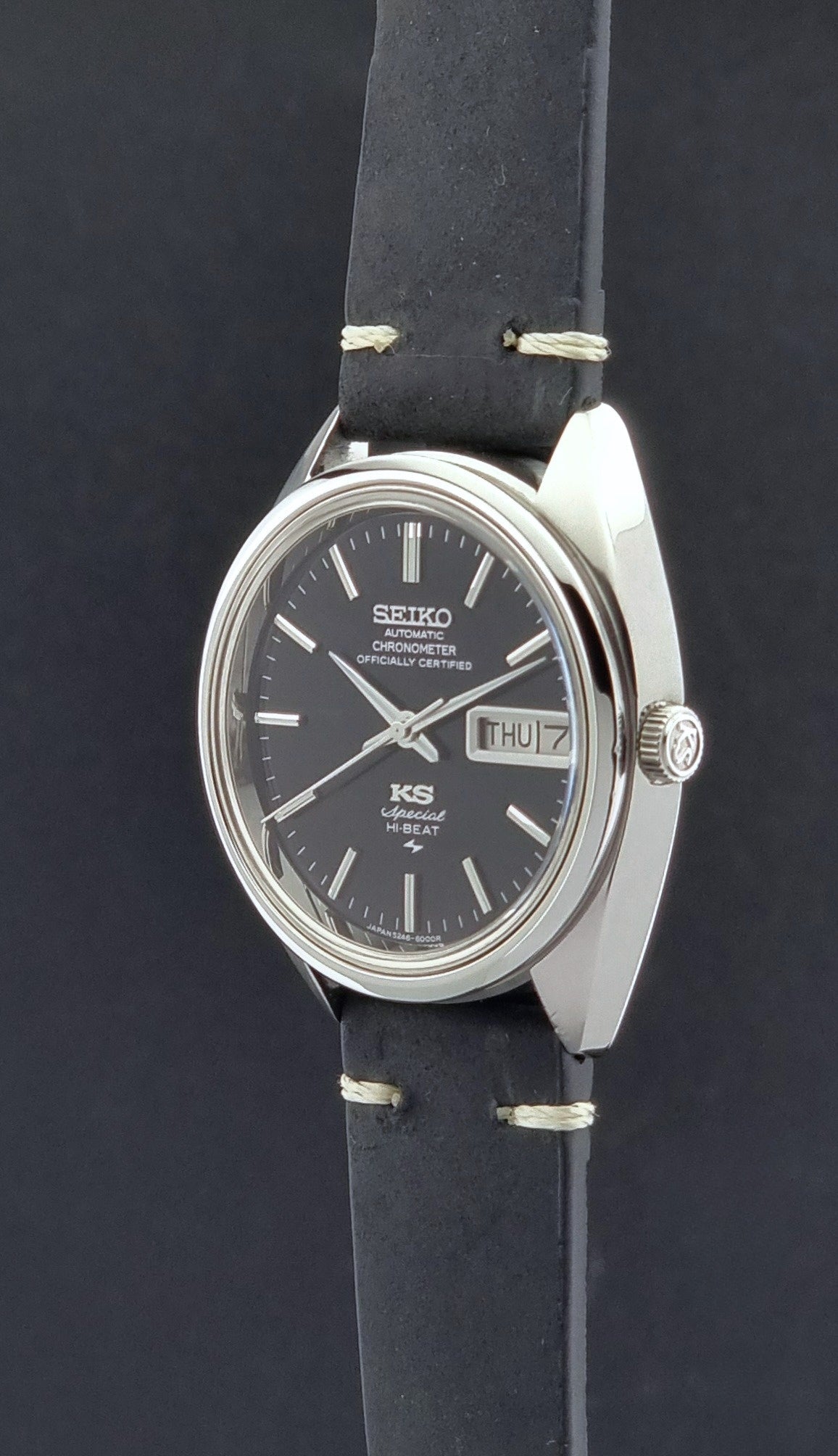 Vintage King Seiko Watch Special 5246-6000 with black leather strap on a dark gray background crown profile view