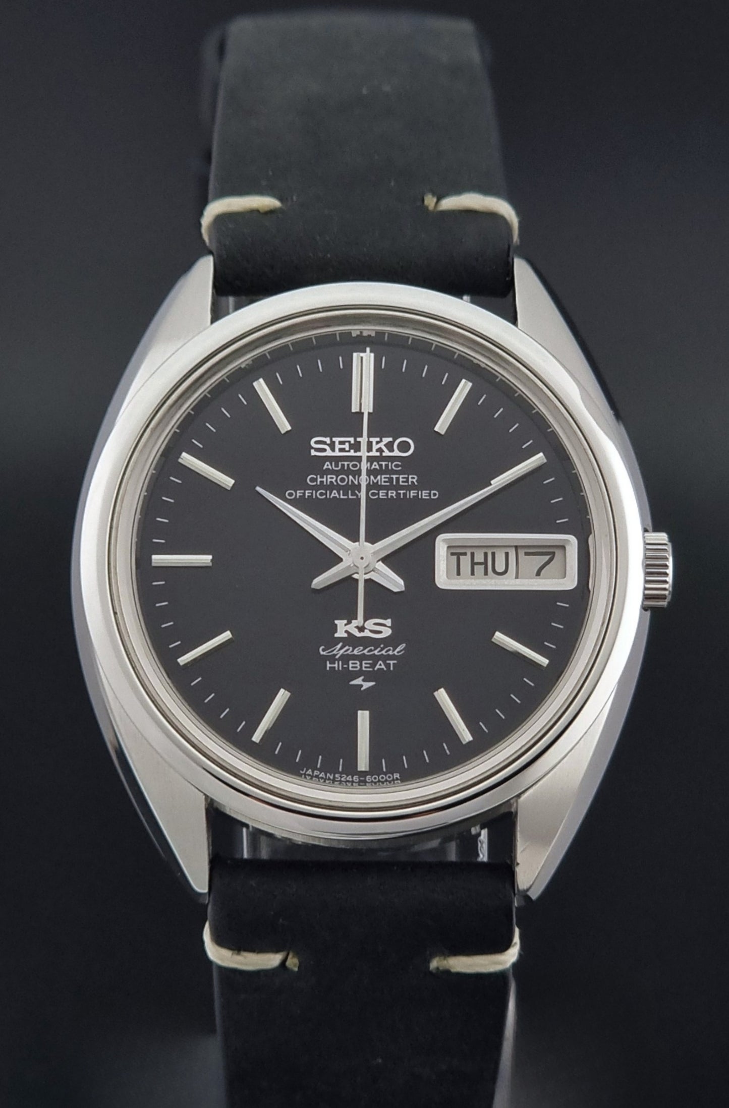 Vintage King Seiko Watch Special 5246-6000 with black leather strap on a dark gray background close dial view