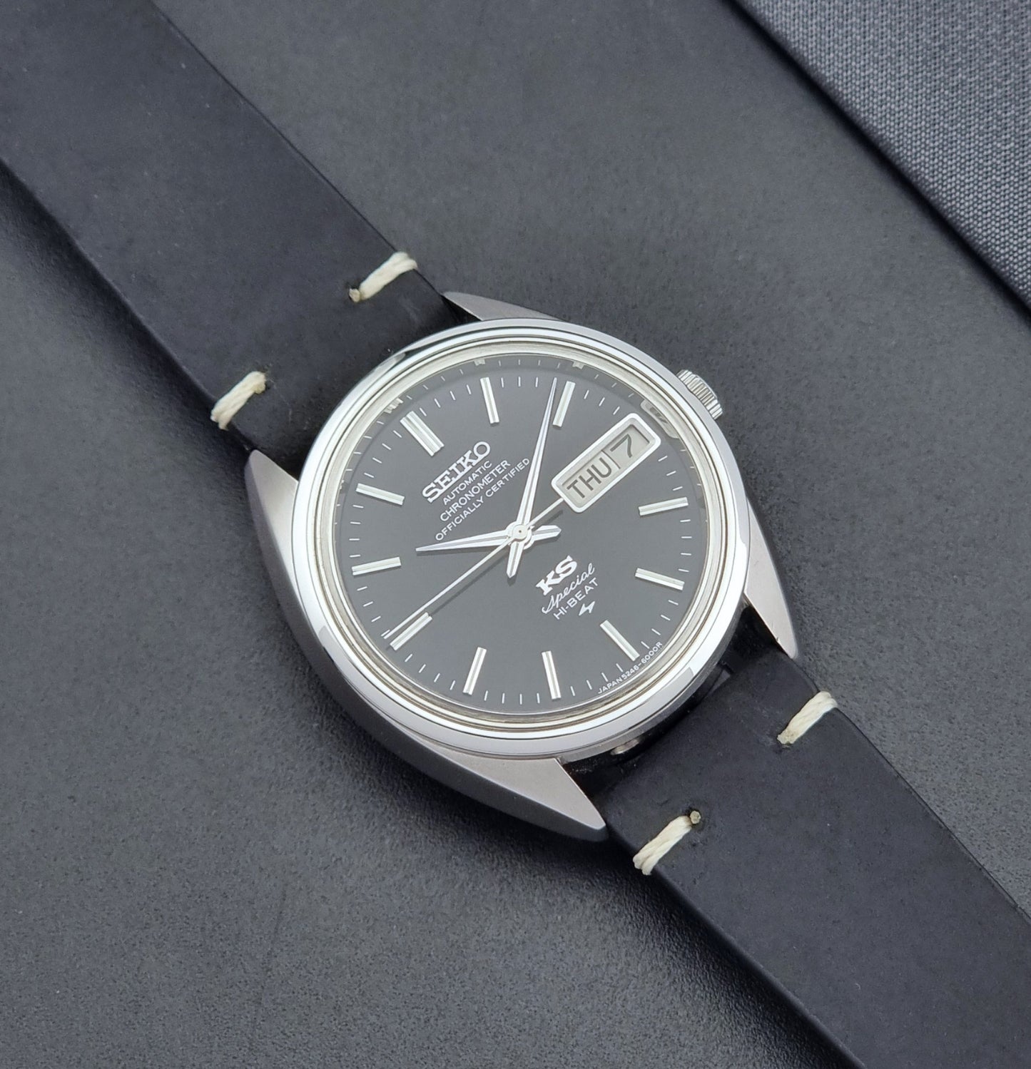 Vintage King Seiko Watch Special 5246-6000 with black leather strap on a dark gray background close up dial view