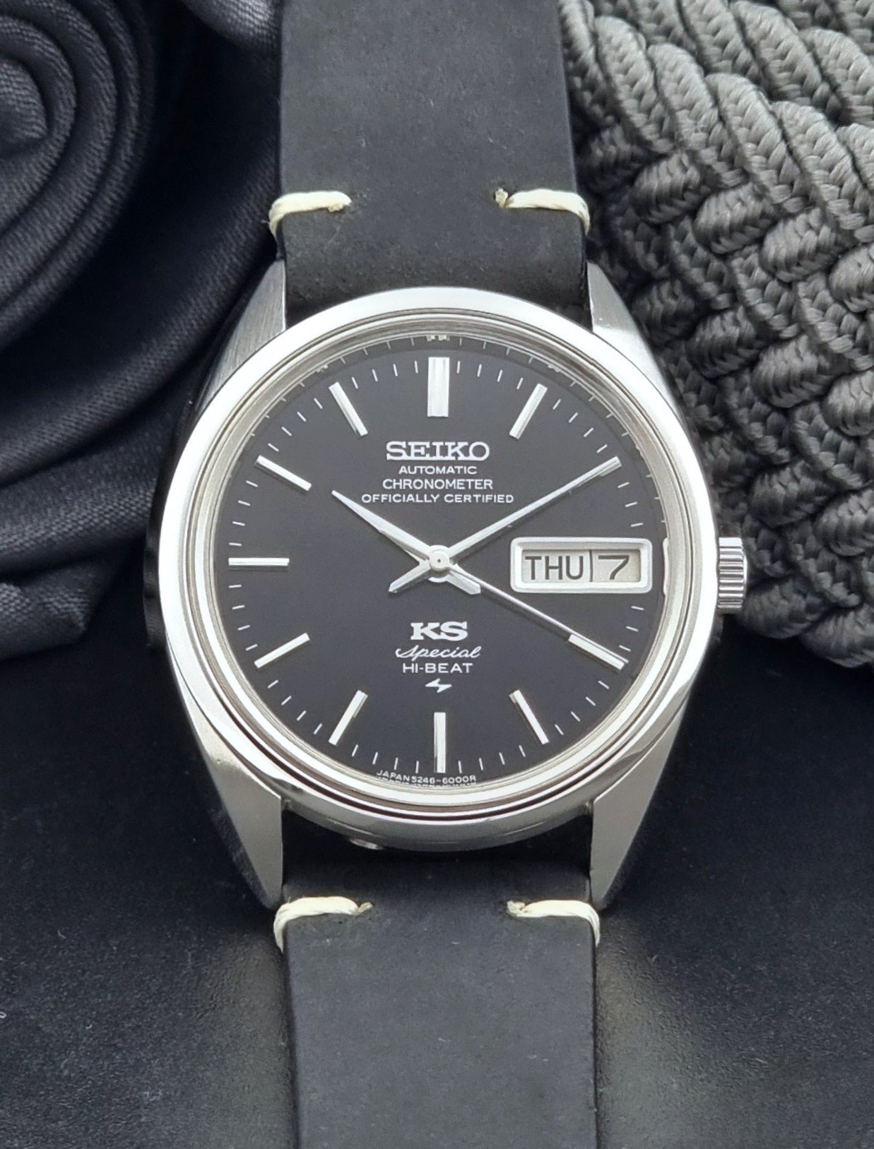 Vintage King Seiko Watch Special 5246-6000 with black leather strap on a dark gray background front view