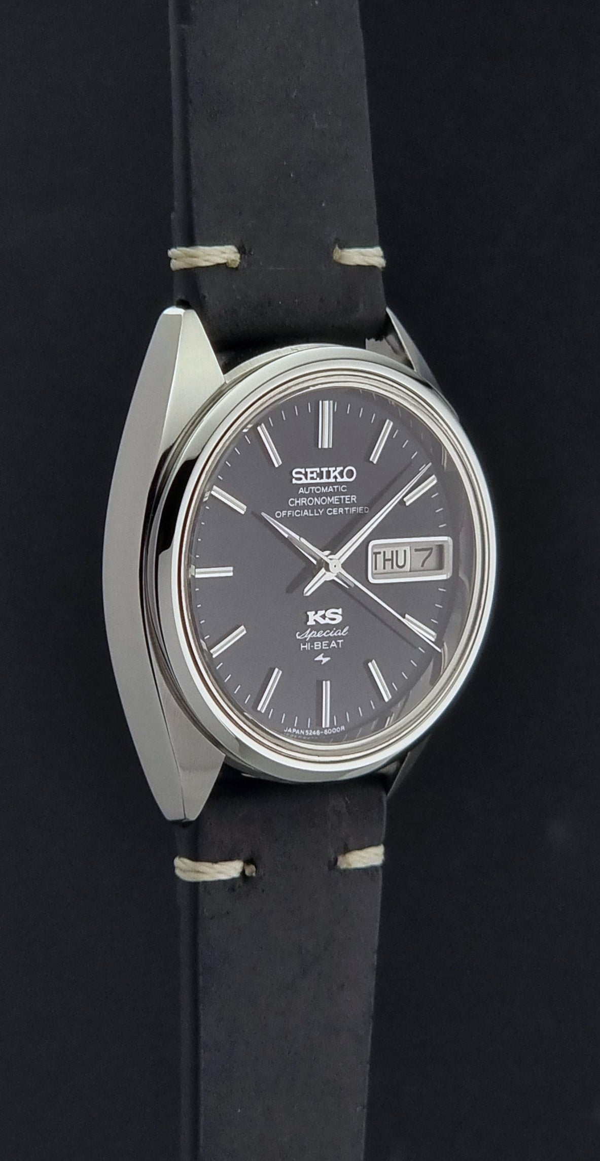 Vintage King Seiko Watch Special 5246-6000 with black leather strap on a dark gray background side profile view