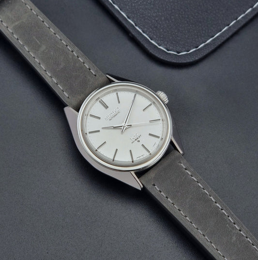 Vintage King Seiko Wristwatch 5621-7020 gray leather strap on a dark gray background dial