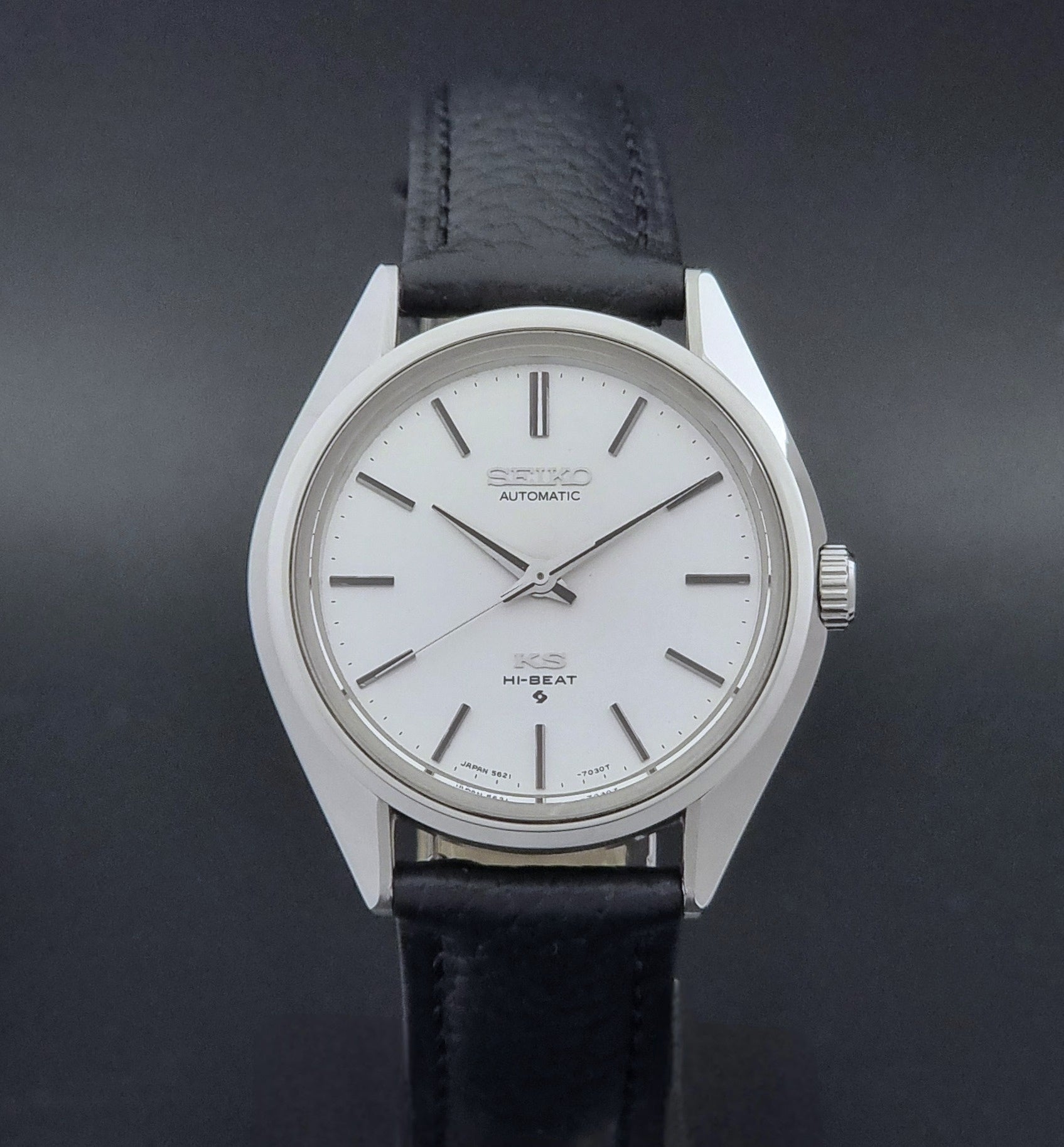 Vintage King Seiko Wristwatch 5621-7022 with a dark leather strap on a green background close dial view